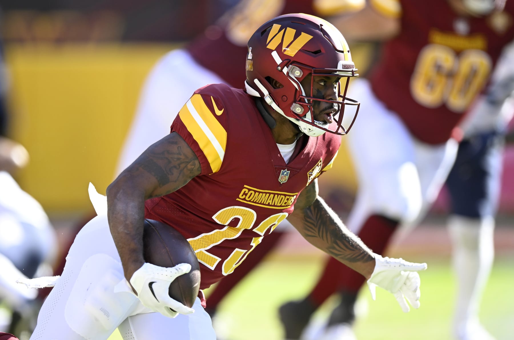 LANDOVER, MARYLAND - OCTOBER 09: J.D. McKissic #23 of the Washington Commanders rushes the ball against the Tennessee Titans at FedExField on October 09, 2022 in Landover, Maryland. (Photo by G Fiume/Getty Images)
