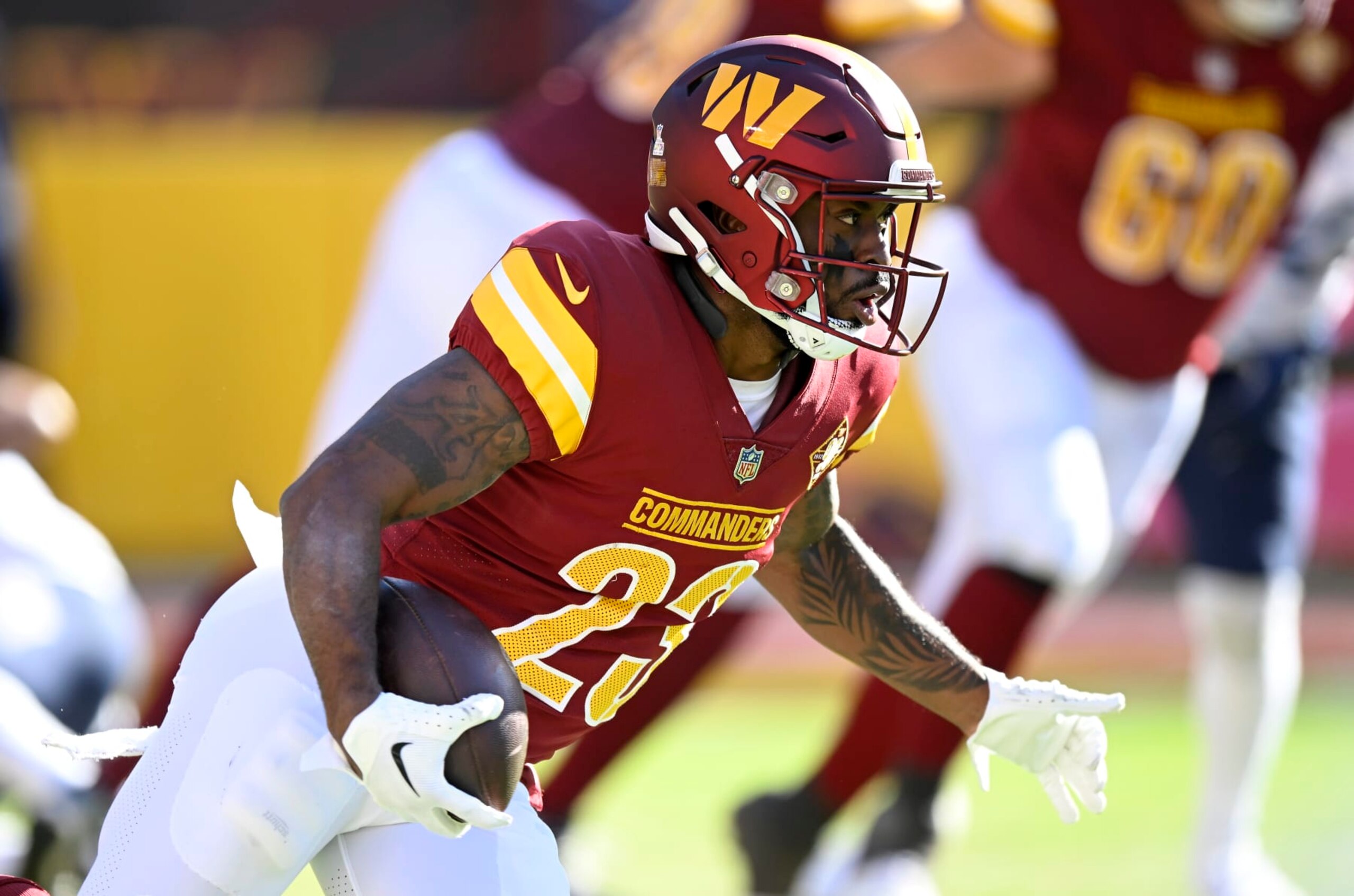 LANDOVER, MARYLAND - OCTOBER 09: J.D. McKissic #23 of the Washington Commanders rushes the ball against the Tennessee Titans at FedExField on October 09, 2022 in Landover, Maryland. (Photo by G Fiume/Getty Images)