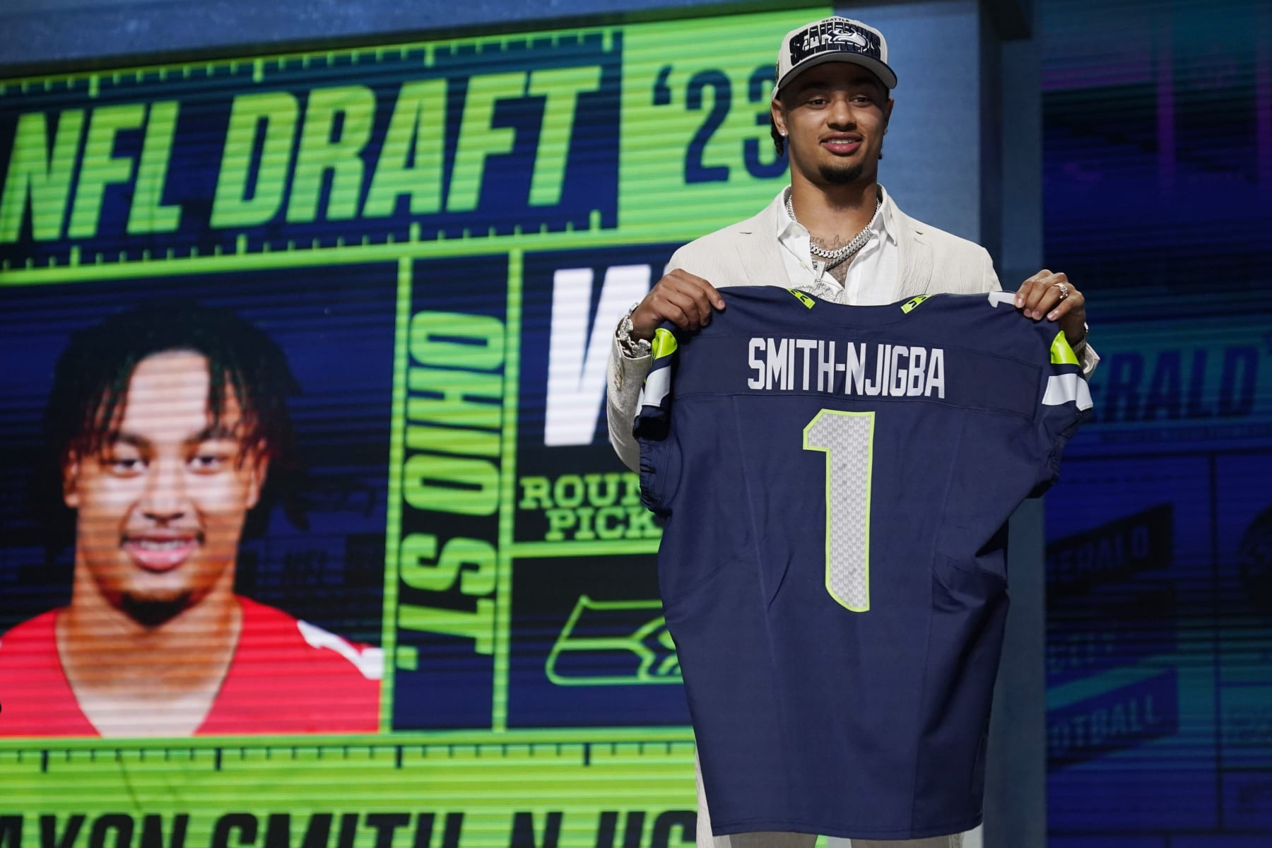 Ohio State wide receiver Jaxon Smith-Njigba holds a jersey after being chosen by the Seattle Seahawks with the 20th overall pick during the first round of the NFL football draft, Thursday, April 27, 2023, in Kansas City, Mo. (AP Photo/Jeff Roberson)