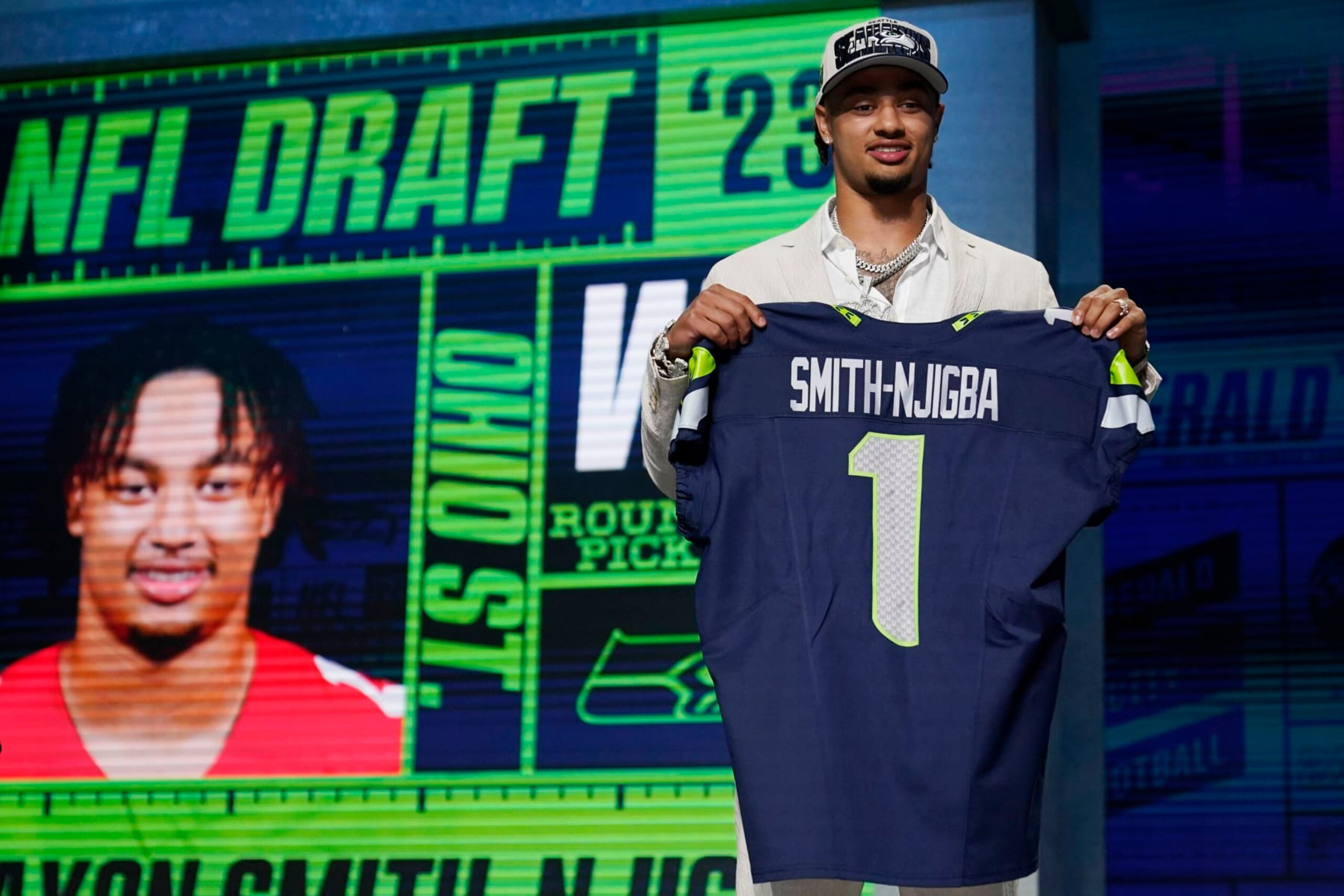 Ohio State wide receiver Jaxon Smith-Njigba holds a jersey after being chosen by the Seattle Seahawks with the 20th overall pick during the first round of the NFL football draft, Thursday, April 27, 2023, in Kansas City, Mo. (AP Photo/Jeff Roberson)