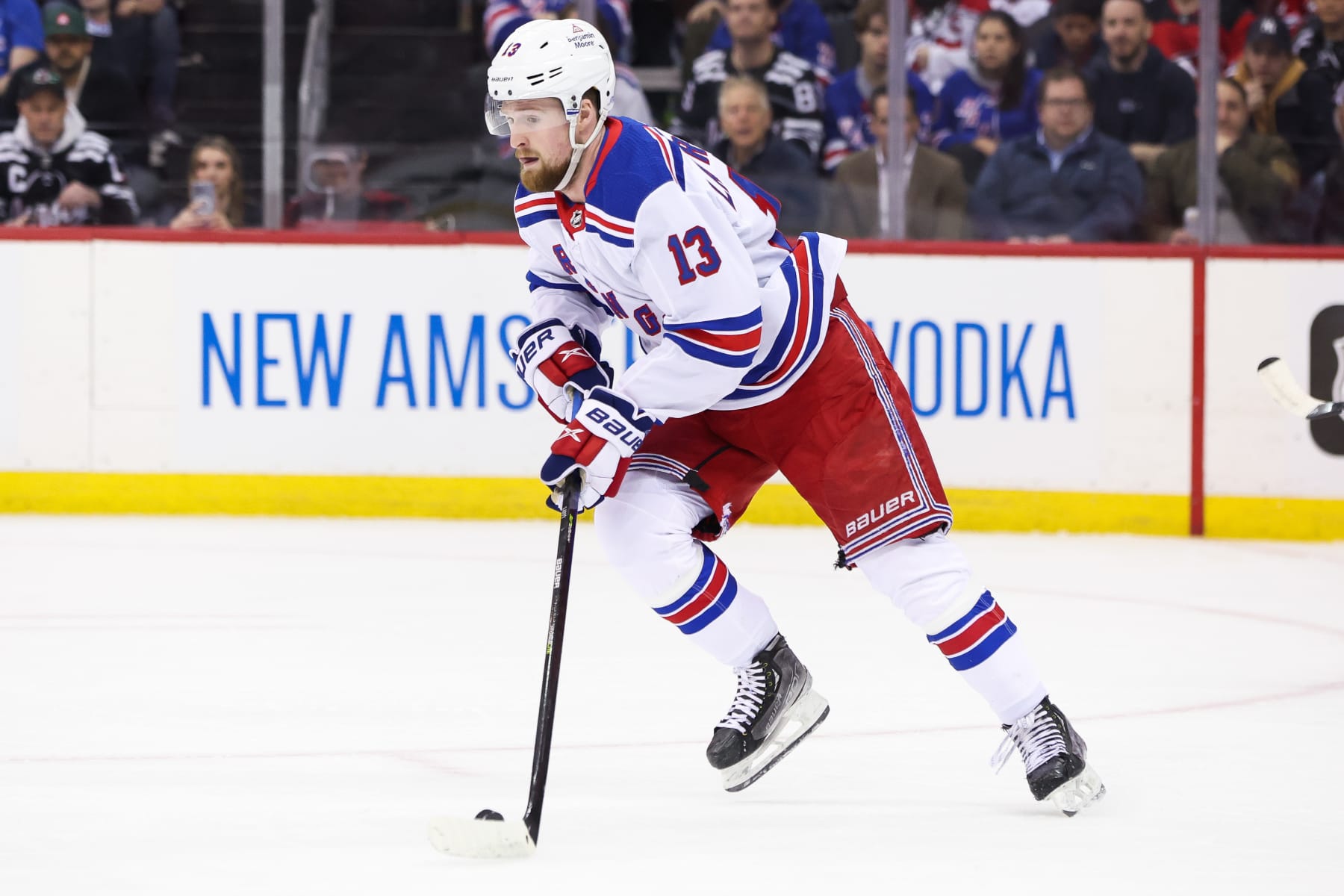 NEWARK, NJ - APRIL 27: New York Rangers left wing Alexis Lafrenière (13) skates with the puck during the National Hockey League game between the New York Rangers and the New Jersey Devils on April 27, 2023 at Prudential Center in Newark, NJ. (Photo by Andrew Mordzynski/Icon Sportswire via Getty Images)