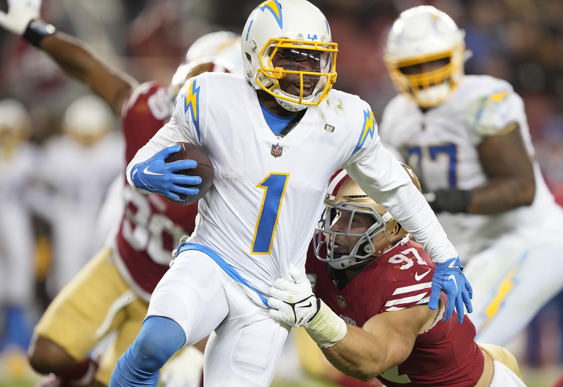 SANTA CLARA, CALIFORNIA - NOVEMBER 13: Nick Bosa #97 of the San Francisco 49ers tackles DeAndre Carter #1 of the Los Angeles Chargers during the fourth quarter at Levi's Stadium on November 13, 2022 in Santa Clara, California. (Photo by Thearon W. Henderson/Getty Images)
