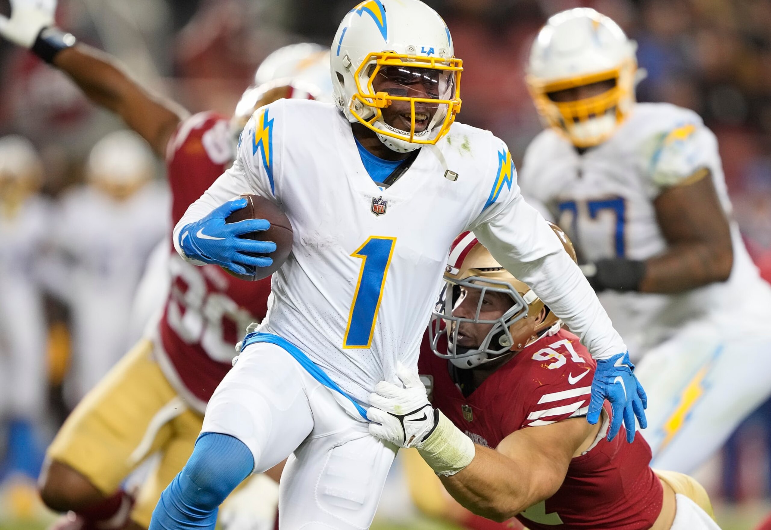SANTA CLARA, CALIFORNIA - NOVEMBER 13: Nick Bosa #97 of the San Francisco 49ers tackles DeAndre Carter #1 of the Los Angeles Chargers during the fourth quarter at Levi's Stadium on November 13, 2022 in Santa Clara, California. (Photo by Thearon W. Henderson/Getty Images)