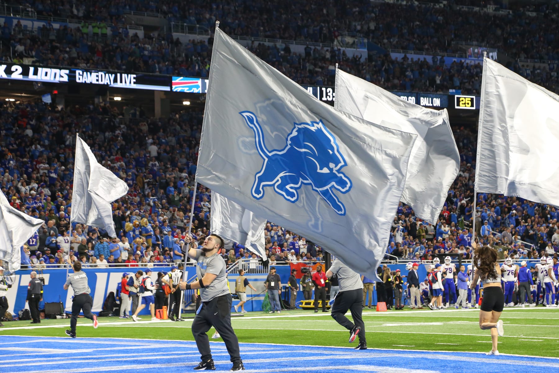 DETROIT, MI - NOVEMBER 24:  A member of the Detroit spirit squad waves a Lions logo flag in the end zone after a score during a regular season NFL football game between the Buffalo Bills and the Detroit Lions on Thanksgiving Day on November 24, 2022 at Ford Field in Detroit, Michigan.  (Photo by Scott W. Grau/Icon Sportswire via Getty Images)