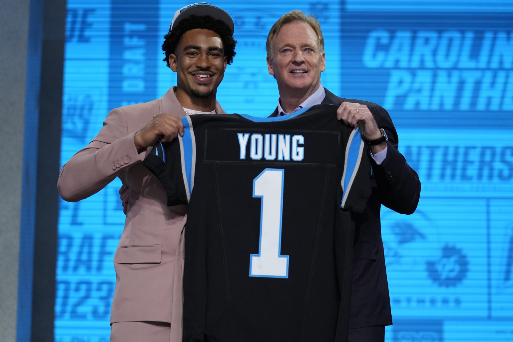 Alabama quarterback Bryce Young gets a jersey from NFL Commissioner Roger Goodell after being chosen by Carolina Panthers with the first overall pick during the first round of the NFL football draft, Thursday, April 27, 2023, in Kansas City, Mo. (AP Photo/Jeff Roberson)