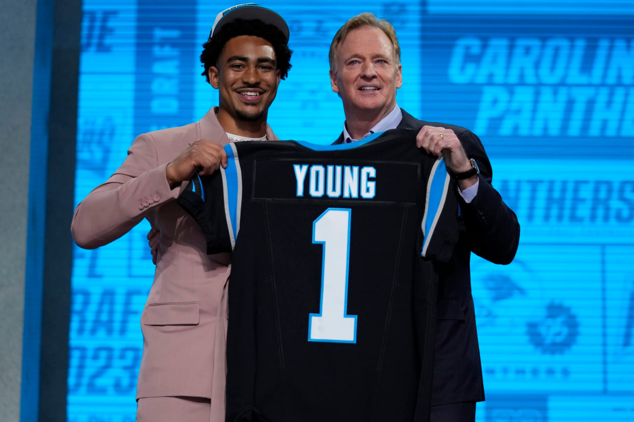 Alabama quarterback Bryce Young gets a jersey from NFL Commissioner Roger Goodell after being chosen by Carolina Panthers with the first overall pick during the first round of the NFL football draft, Thursday, April 27, 2023, in Kansas City, Mo. (AP Photo/Jeff Roberson)