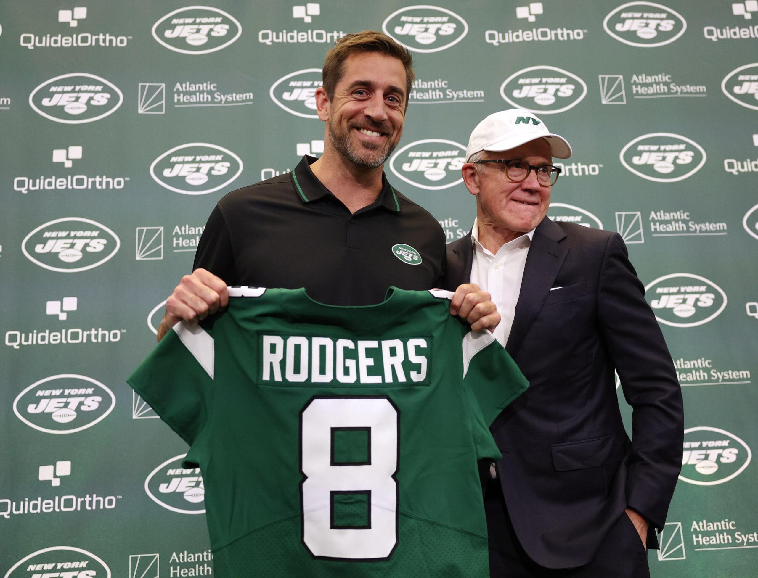 Aaron Rodgers (left) and Woody Johnson