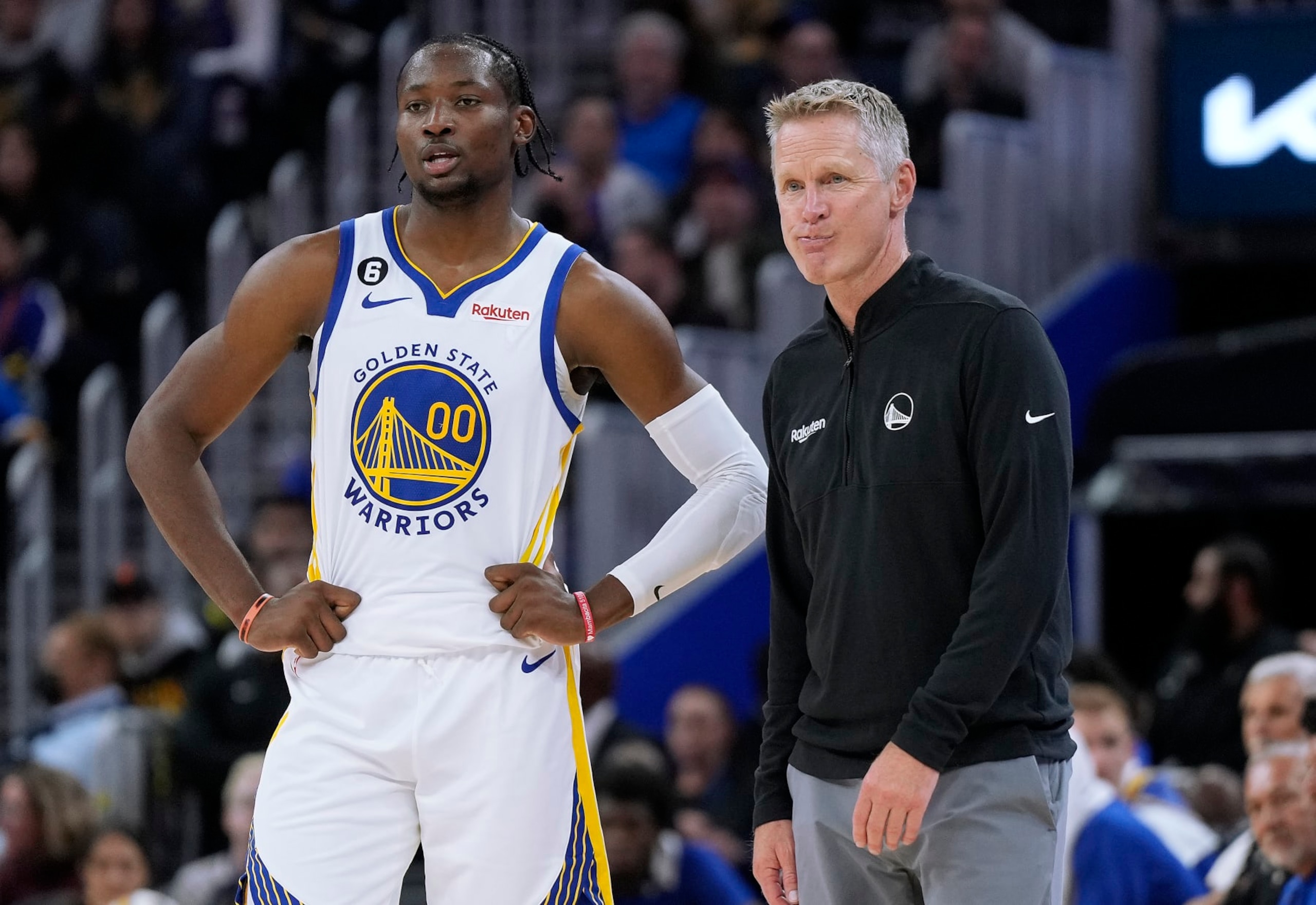 SAN FRANCISCO, CALIFORNIA - OCTOBER 14: Head coach Steve Kerr and Jonathan Kuminga #00 of the Golden State Warriors talk with each other during a break in the action against the Denver Nuggets in the second half of an NBA basketball game at Chase Center on October 14, 2022 in San Francisco, California. NOTE TO USER: User expressly acknowledges and agrees that, by downloading and or using this photograph, User is consenting to the terms and conditions of the Getty Images License Agreement. (Photo by Thearon W. Henderson/Getty Images)