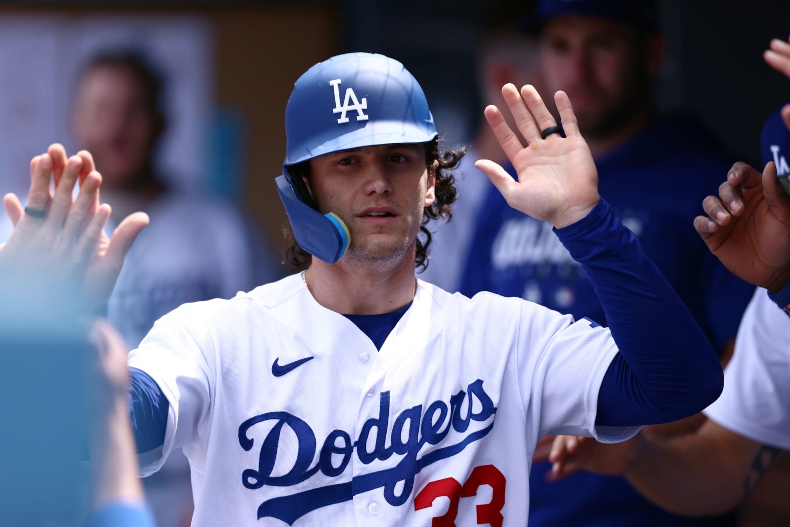 LOS ANGELES, CALIFORNIA - APRIL 30: James Outman #33 of the Los Angeles Dodgers celebrates his run scored in with teammates in the dugout during the fourth inning against the St. Louis Cardinals at Dodger Stadium on April 30, 2023 in Los Angeles, California. (Photo by Katelyn Mulcahy/Getty Images)
