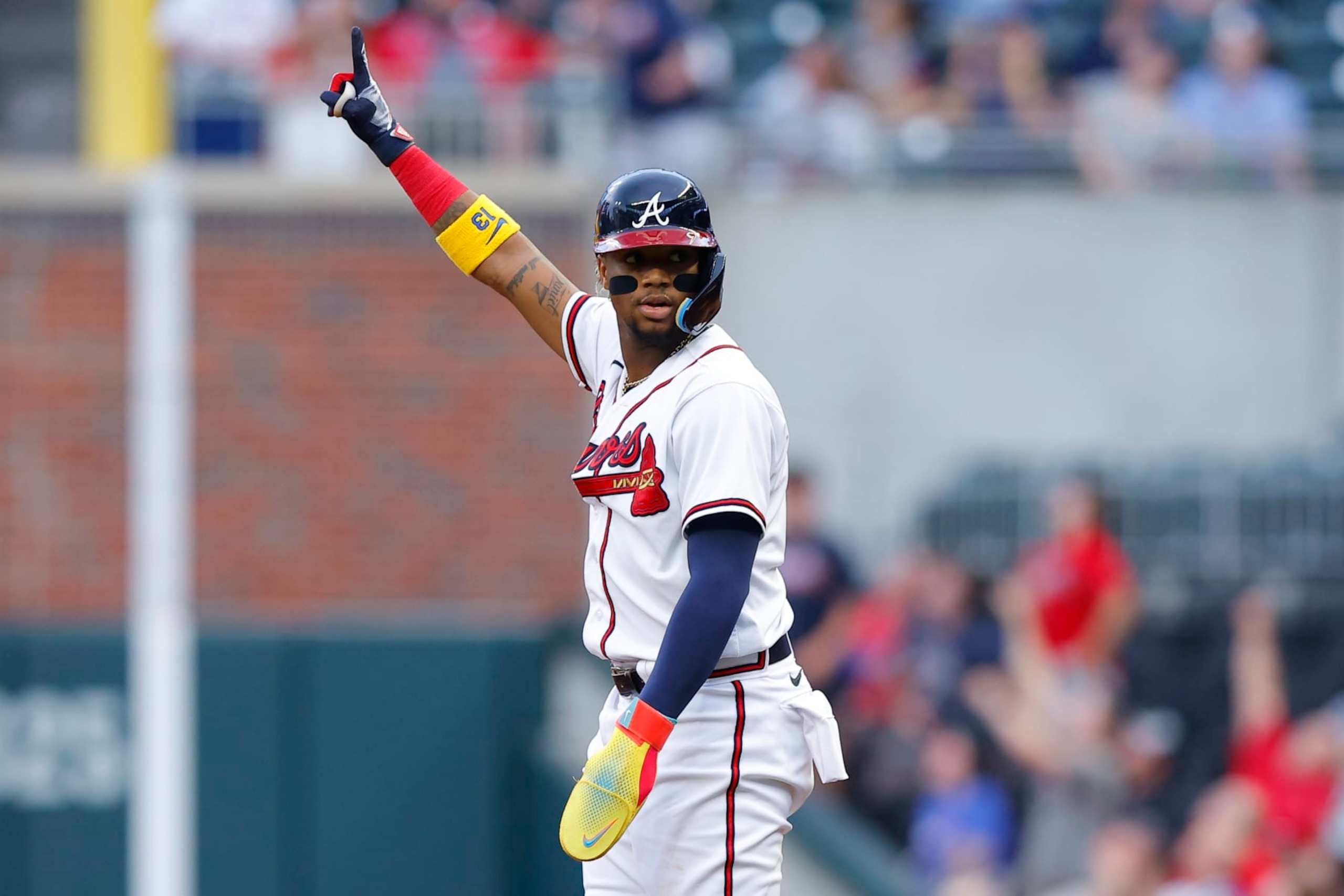 ATLANTA, GA - MAY 09: Ronald Acuna Jr. #13 of the Atlanta Braves reacts after Matt Olson's home run during the first inning against the Boston Red Sox at Truist Park on May 9, 2023 in Atlanta, Georgia. (Photo by Todd Kirkland/Getty Images)