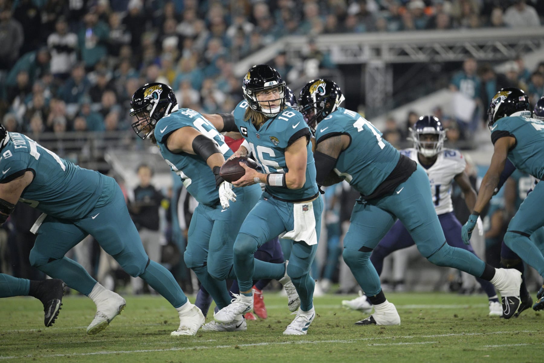 Jacksonville Jaguars quarterback Trevor Lawrence (16) runs a play during the second half of an NFL football game against the Tennessee Titans, Saturday, Jan. 7, 2023, in Jacksonville, Fla. (AP Photo/Phelan M. Ebenhack)
