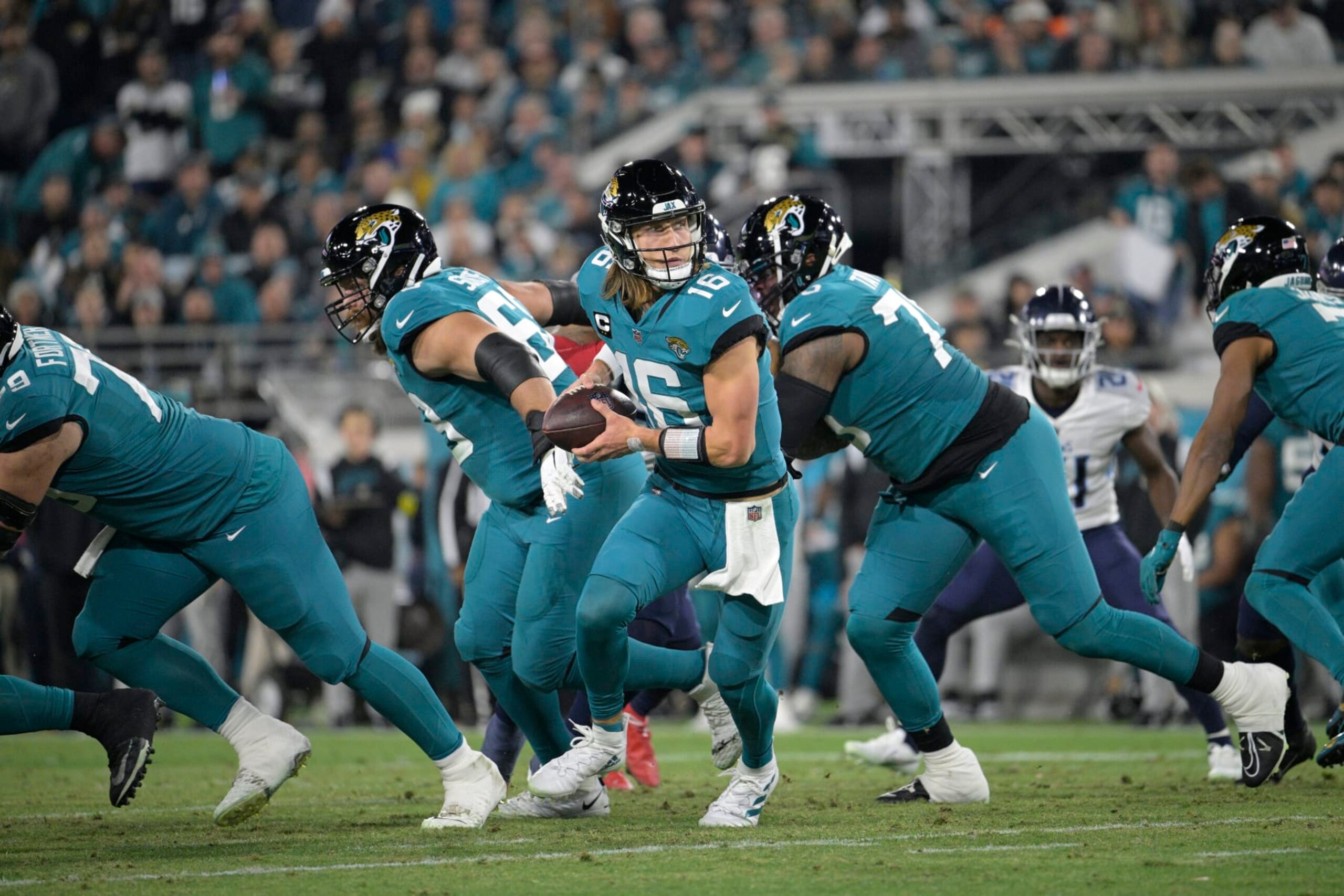 Jacksonville Jaguars quarterback Trevor Lawrence (16) runs a play during the second half of an NFL football game against the Tennessee Titans, Saturday, Jan. 7, 2023, in Jacksonville, Fla. (AP Photo/Phelan M. Ebenhack)