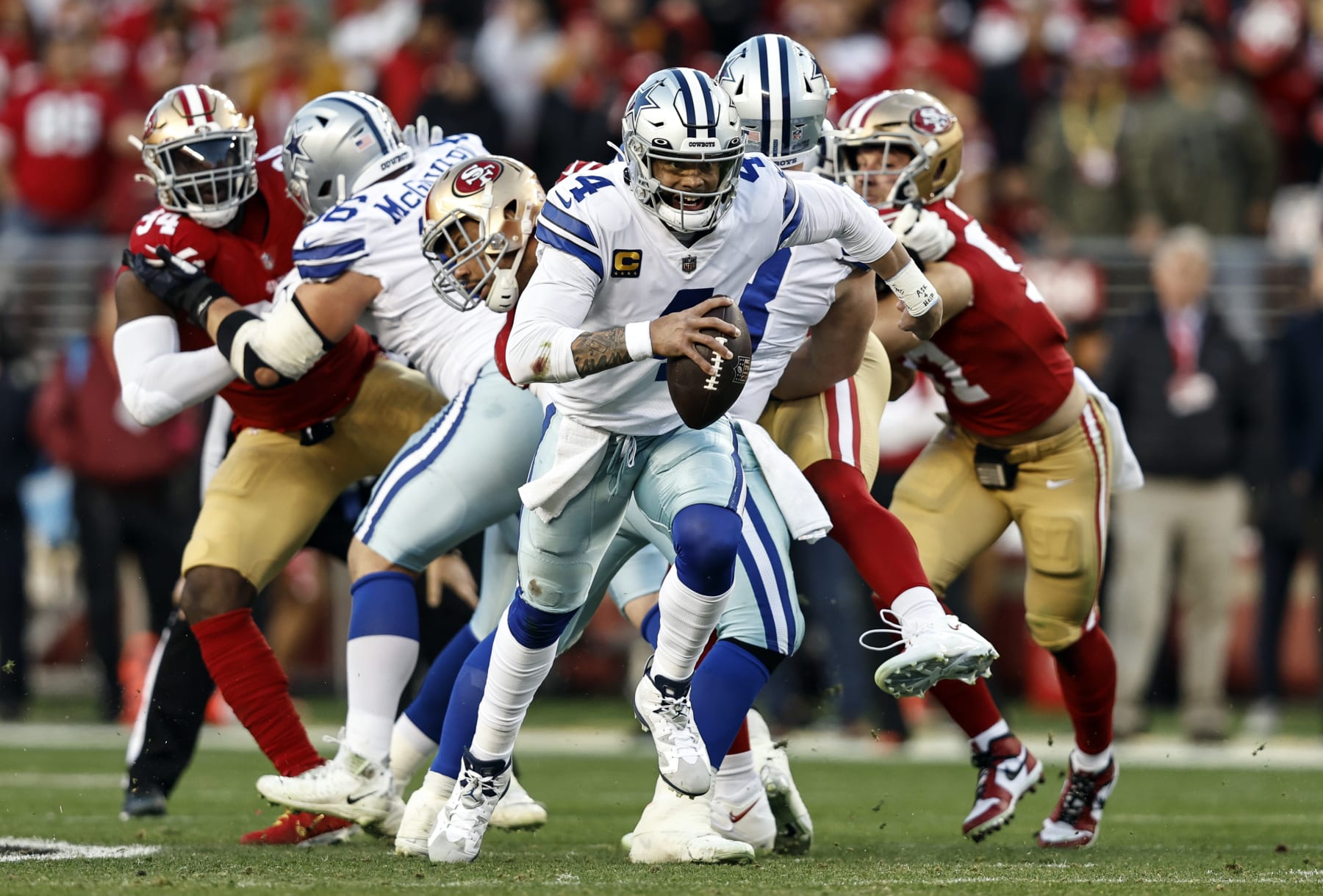 SANTA CLARA, CALIFORNIA - JANUARY 22: Dak Prescott #4 of the Dallas Cowboys scrambles and runs with the ball during an NFL divisional round playoff football game between the San Francisco 49ers and the Dallas Cowboys at Levi's Stadium on January 22, 2023 in Santa Clara, California. (Photo by Michael Owens/Getty Images)