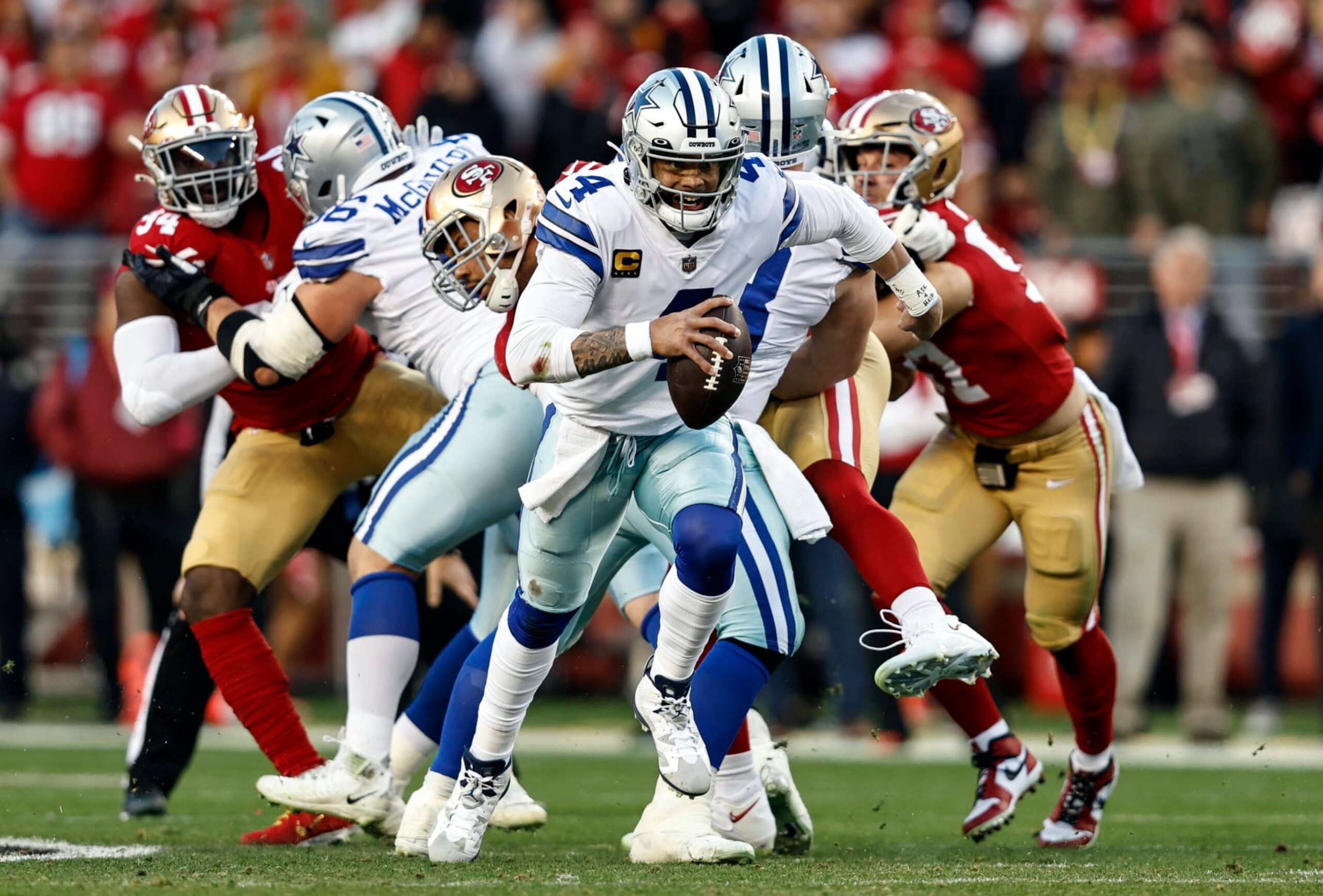 SANTA CLARA, CALIFORNIA - JANUARY 22: Dak Prescott #4 of the Dallas Cowboys scrambles and runs with the ball during an NFL divisional round playoff football game between the San Francisco 49ers and the Dallas Cowboys at Levi's Stadium on January 22, 2023 in Santa Clara, California. (Photo by Michael Owens/Getty Images)
