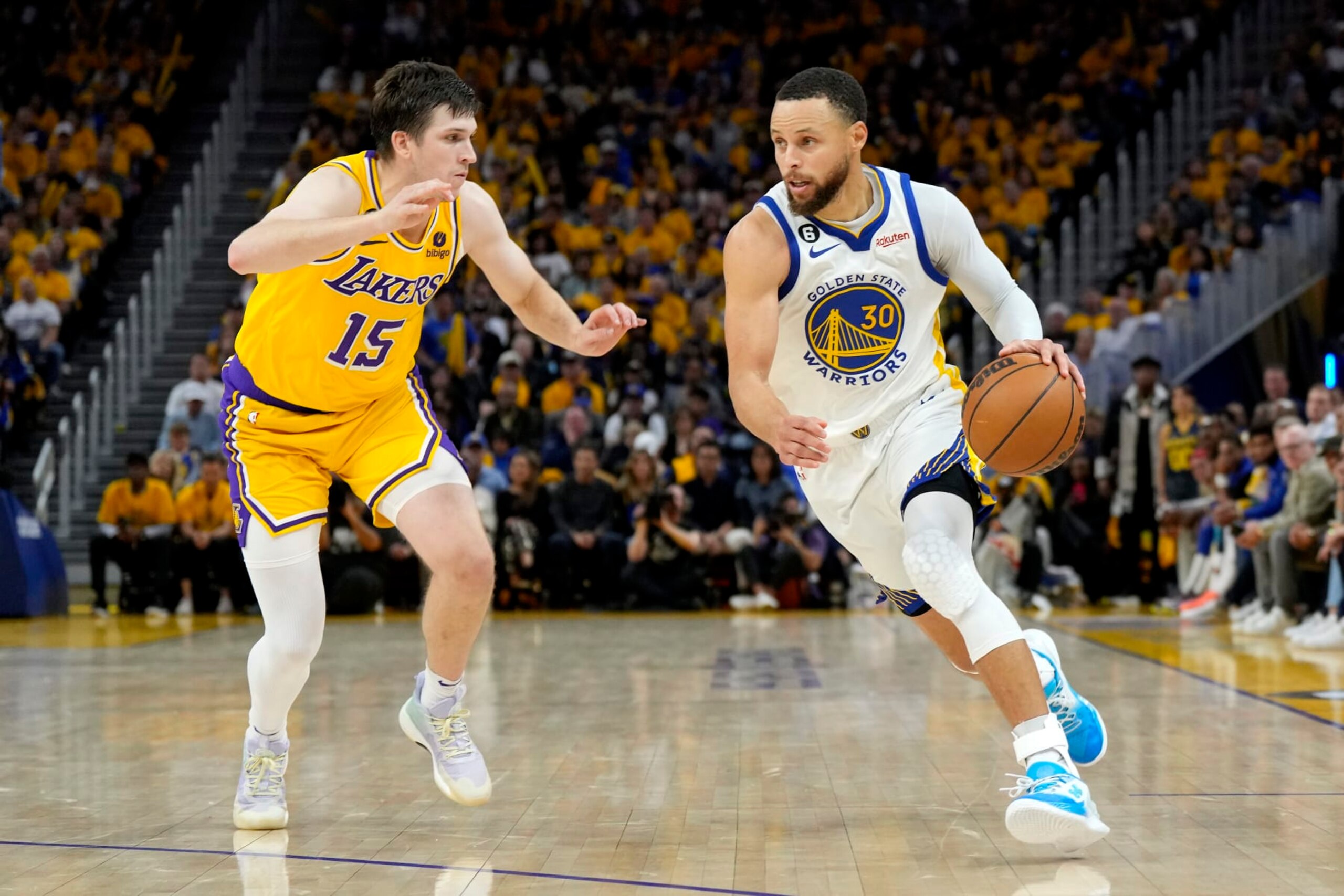 SAN FRANCISCO, CALIFORNIA - MAY 10: Stephen Curry #30 of the Golden State Warriors drives past Austin Reaves #15 of the Los Angeles Lakers during the fourth quarter in game five of the Western Conference Semifinal Playoffs at Chase Center on May 10, 2023 in San Francisco, California. NOTE TO USER: User expressly acknowledges and agrees that, by downloading and or using this photograph, User is consenting to the terms and conditions of the Getty Images License Agreement. (Photo by Thearon W. Henderson/Getty Images)