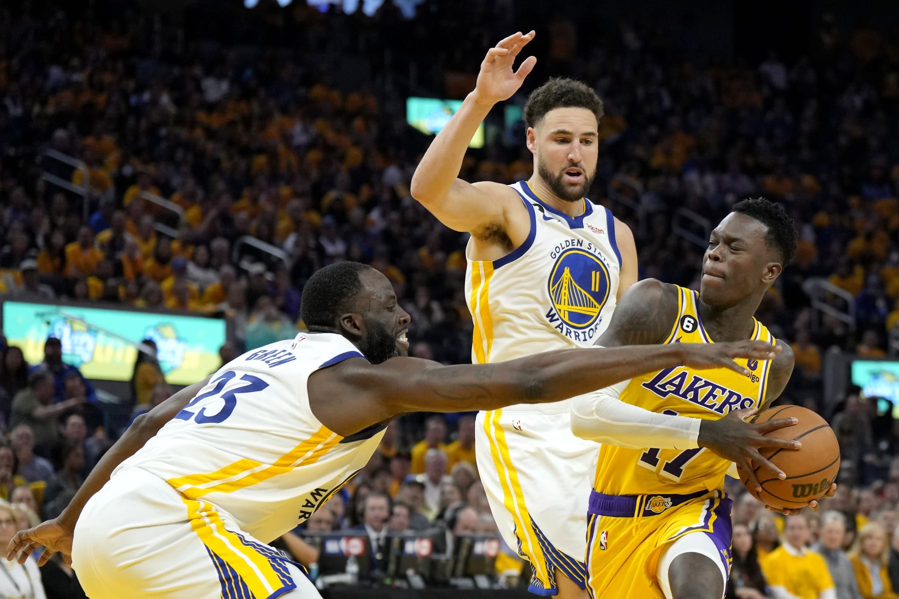 SAN FRANCISCO, CALIFORNIA - MAY 10: Dennis Schroder #17 of the Los Angeles Lakers drives to the basket against Draymond Green #23 and Klay Thompson #11 of the Golden State Warriors during the second quarter in game five of the Western Conference Semifinal Playoffs at Chase Center on May 10, 2023 in San Francisco, California. NOTE TO USER: User expressly acknowledges and agrees that, by downloading and or using this photograph, User is consenting to the terms and conditions of the Getty Images License Agreement. (Photo by Thearon W. Henderson/Getty Images)