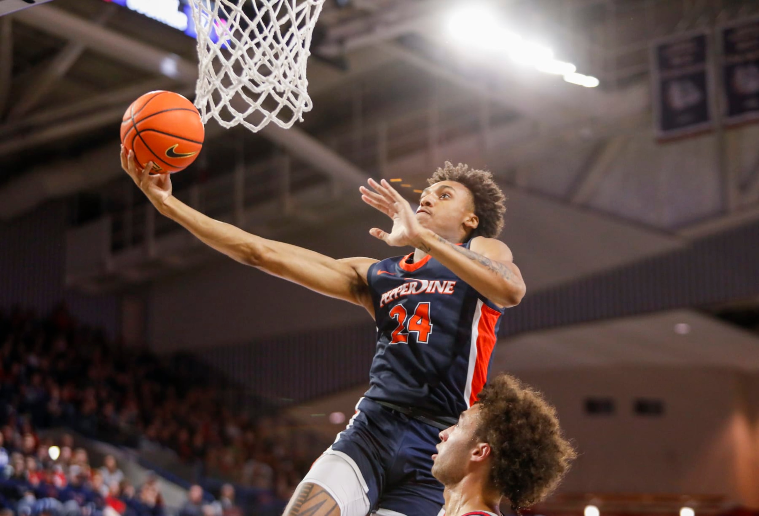 SPOKANE, WA - DECEMBER 31: Pepperdine Waves forward Maxwell Lewis (24) jumps and lays the ball in the net during the game between the Pepperdine Waves and the Gonzaga Bulldogs on December 31, 2022, at McCarthey Athletic Center in Spokane, WA. (Photo by Oliver McKenna/Icon Sportswire via Getty Images)