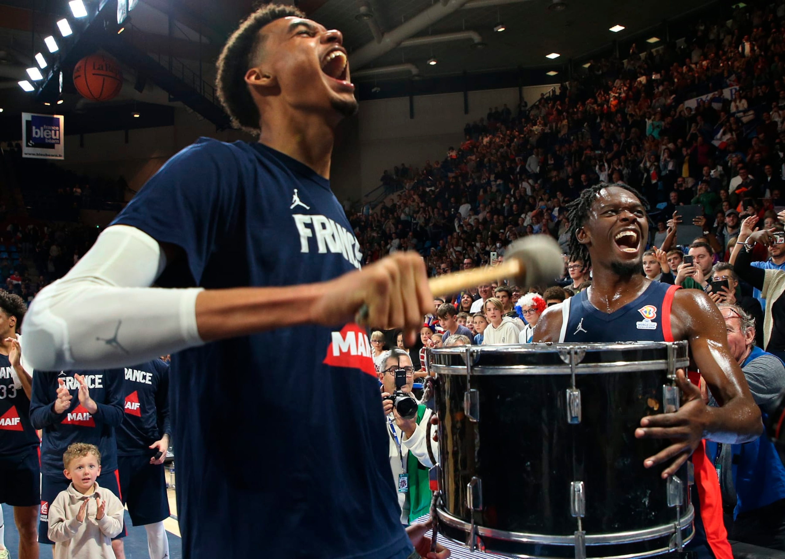 FILE - France's Victor Wembanyama, left, plays the drums after the FIBA Basketball World Cup 2023 European Qualifiers match between France and Bosnia Herzegovina in Pau, southwestern France, Monday, Nov. 14, 2022. Wembanyama's season for Metropolitans 92 in the French league keeps getting better. He's scored at least 30 points in his last two games, and his team has now won seven consecutive contests. That's helped them pull into a first-place tie with Cholet with a 7-1 record.(AP Photo/Bob Edme, File)