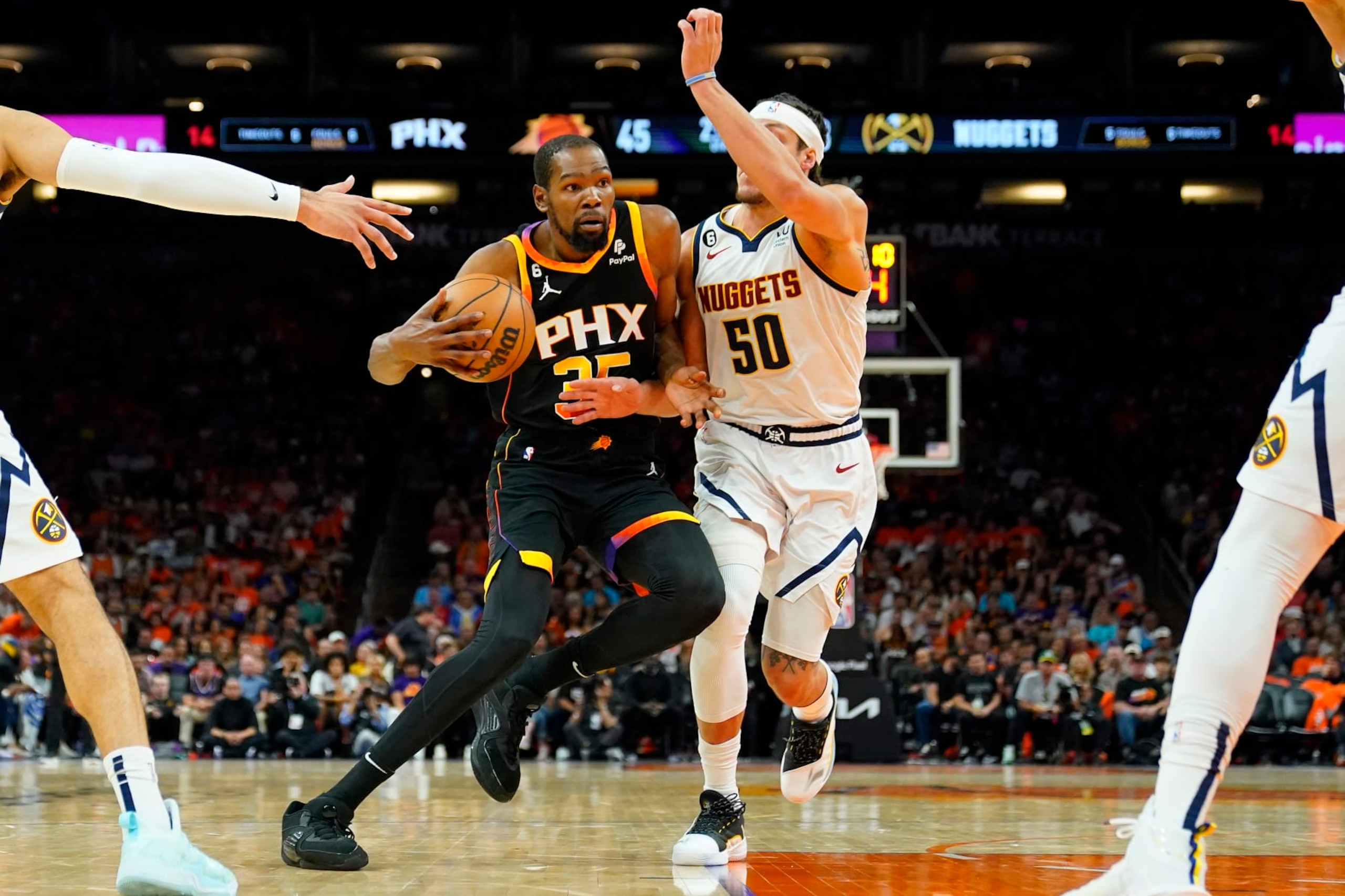 Phoenix Suns forward Kevin Durant (35) drives as Denver Nuggets forward Aaron Gordon (50) defends during the first half of Game 6 of an NBA basketball Western Conference semifinal game, Thursday, May 11, 2023, in Phoenix. (AP Photo/Matt York)