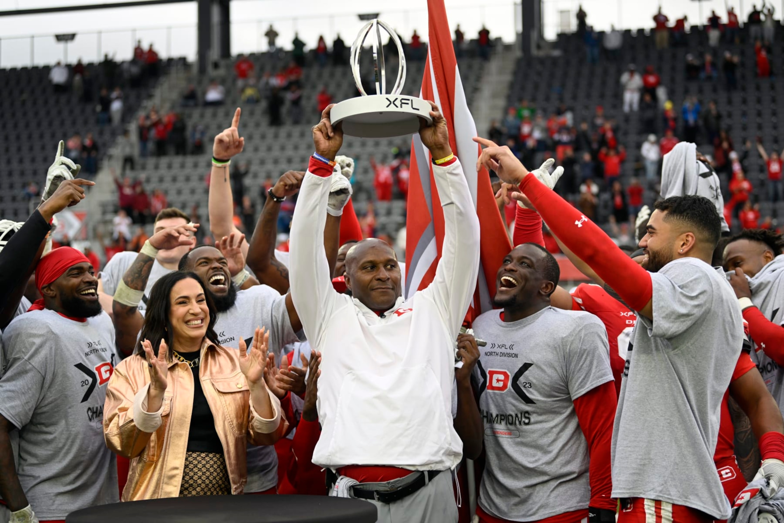 WASHINGTON, DC - APRIL 30: Defenders head coach Reggie Barlow, center hold up the division trophy after the DC Defenders defeat the Seattle Sea Dragons 37-21 for the XFL North Division Championship on April 30, 2023 at Audi Field in Washington, DC. (Photo by John McDonnell/The Washington Post via Getty Images)