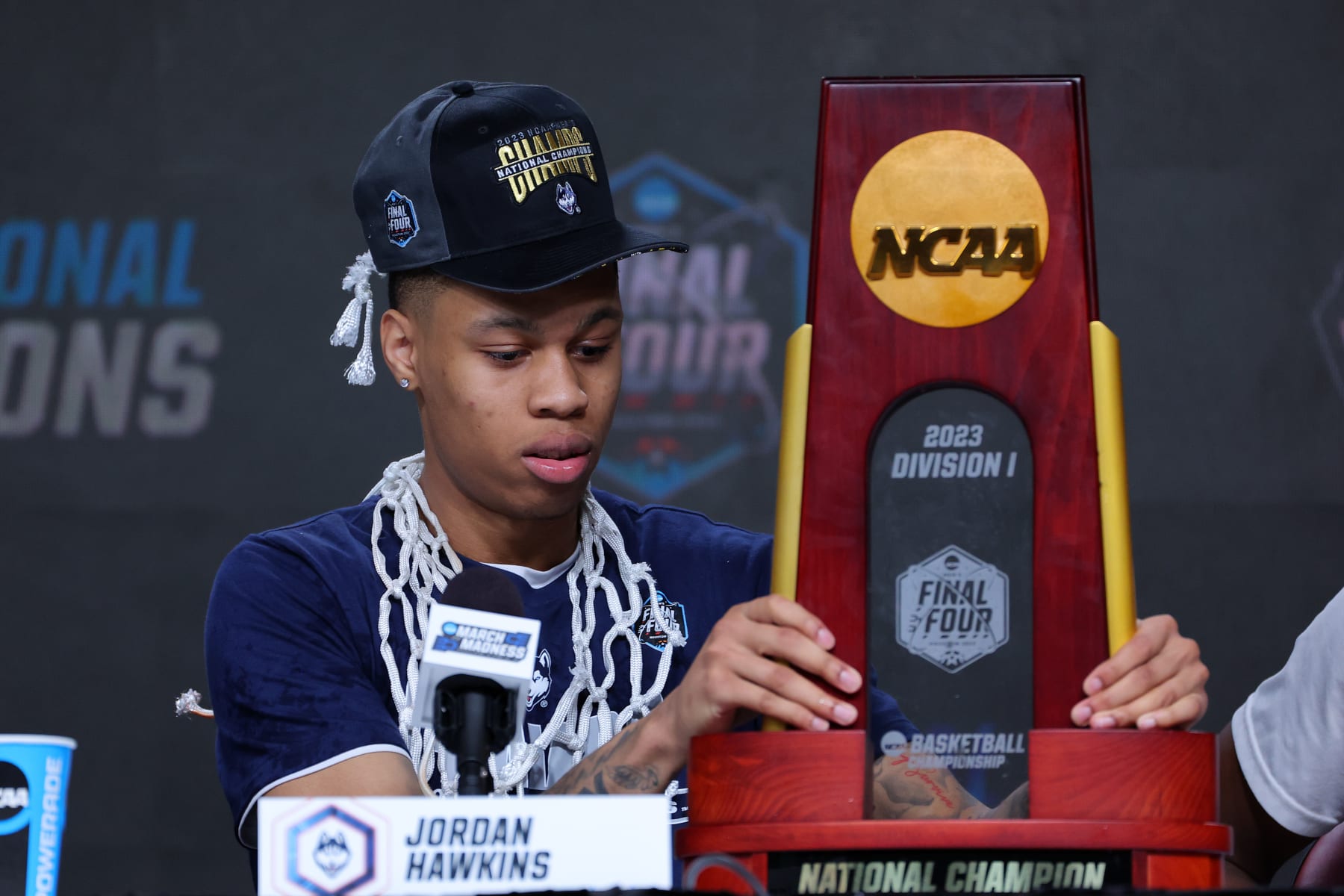 HOUSTON, TEXAS - APRIL 03: Jordan Hawkins #24 of the Connecticut Huskies arrives with the trophy to the press conference after his team defeated the San Diego State Aztecs to win the NCAA Men's Basketball Tournament National Championship at NRG Stadium on April 03, 2023 in Houston, Texas. (Photo by C. Morgan Engel/NCAA Photos via Getty Images)