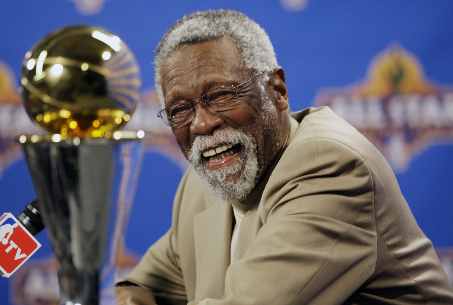 FILE - NBA great Bill Russell reacts at a news conference as he learns the most valuable player award for the NBA basketball championships has been renamed the Bill Russell NBA Finals Most Valuable Player Award, Feb. 14, 2009, in Phoenix. Russell has died at age 88. His family said on social media that Russell died on Sunday, July 31, 2022. Russell anchored a Boston Celtics dynasty that won 11 titles in 13 years. (AP Photo/Matt York, file)