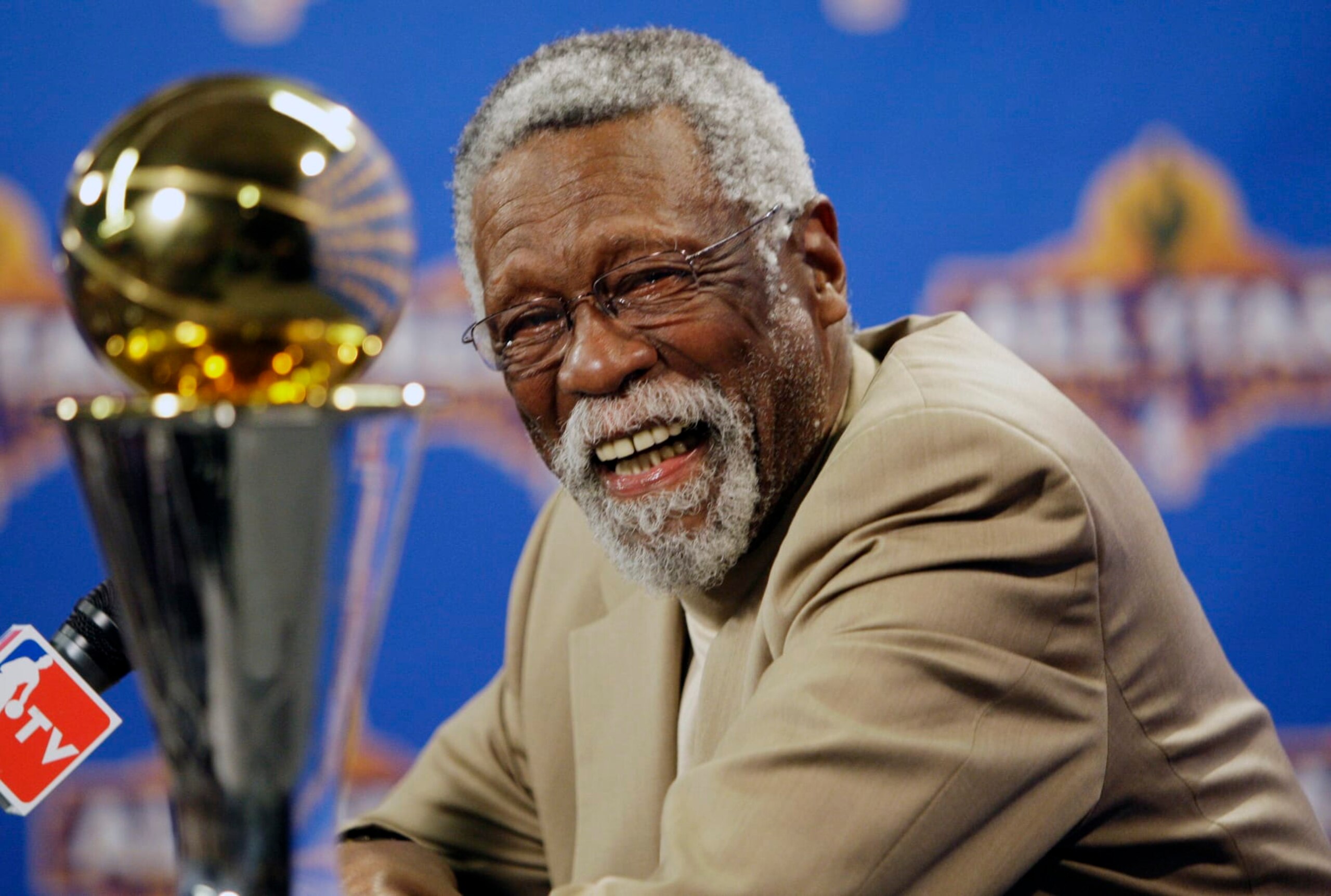 FILE - NBA great Bill Russell reacts at a news conference as he learns the most valuable player award for the NBA basketball championships has been renamed the Bill Russell NBA Finals Most Valuable Player Award, Feb. 14, 2009, in Phoenix. Russell has died at age 88. His family said on social media that Russell died on Sunday, July 31, 2022. Russell anchored a Boston Celtics dynasty that won 11 titles in 13 years. (AP Photo/Matt York, file)