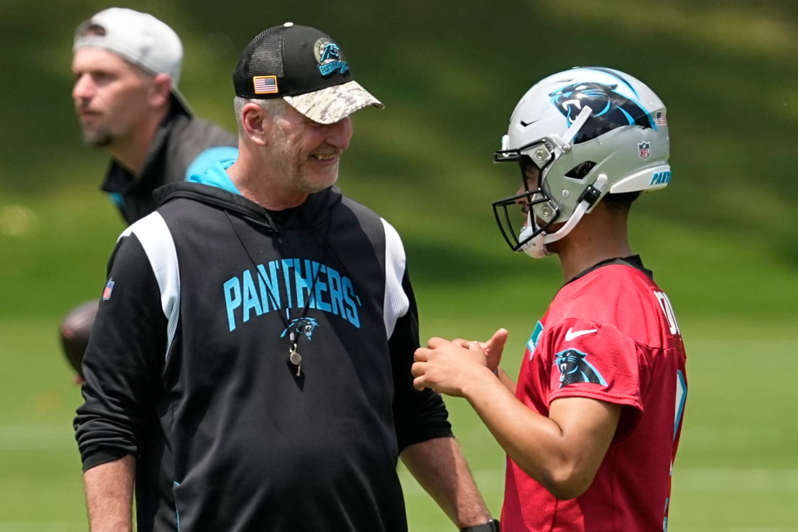 Carolina Panthers quarterback Bryce Young talks with head coach Frank Reich during the NFL football team's rookie minicamp, Friday, May 12, 2023, in Charlotte, N.C. (AP Photo/Chris Carlson)