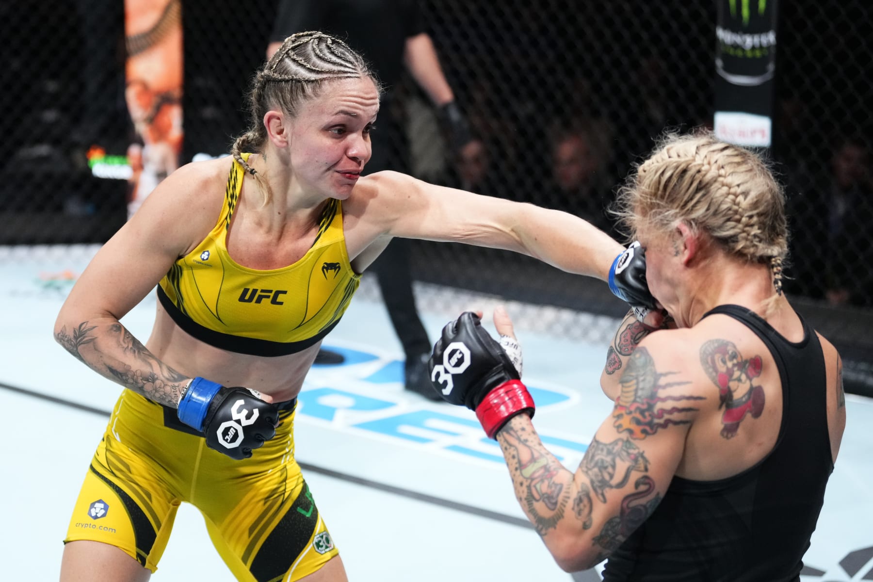CHARLOTTE, NORTH CAROLINA - MAY 13: (L-R) Tainara Lisboa of Brazil punches Jessica-Rose Clark of Australia in a bantamweight fight during the UFC Fight Night event at Spectrum Center on May 13, 2023 in Charlotte, North Carolina. (Photo by Jeff Bottari/Zuffa LLC via Getty Images)