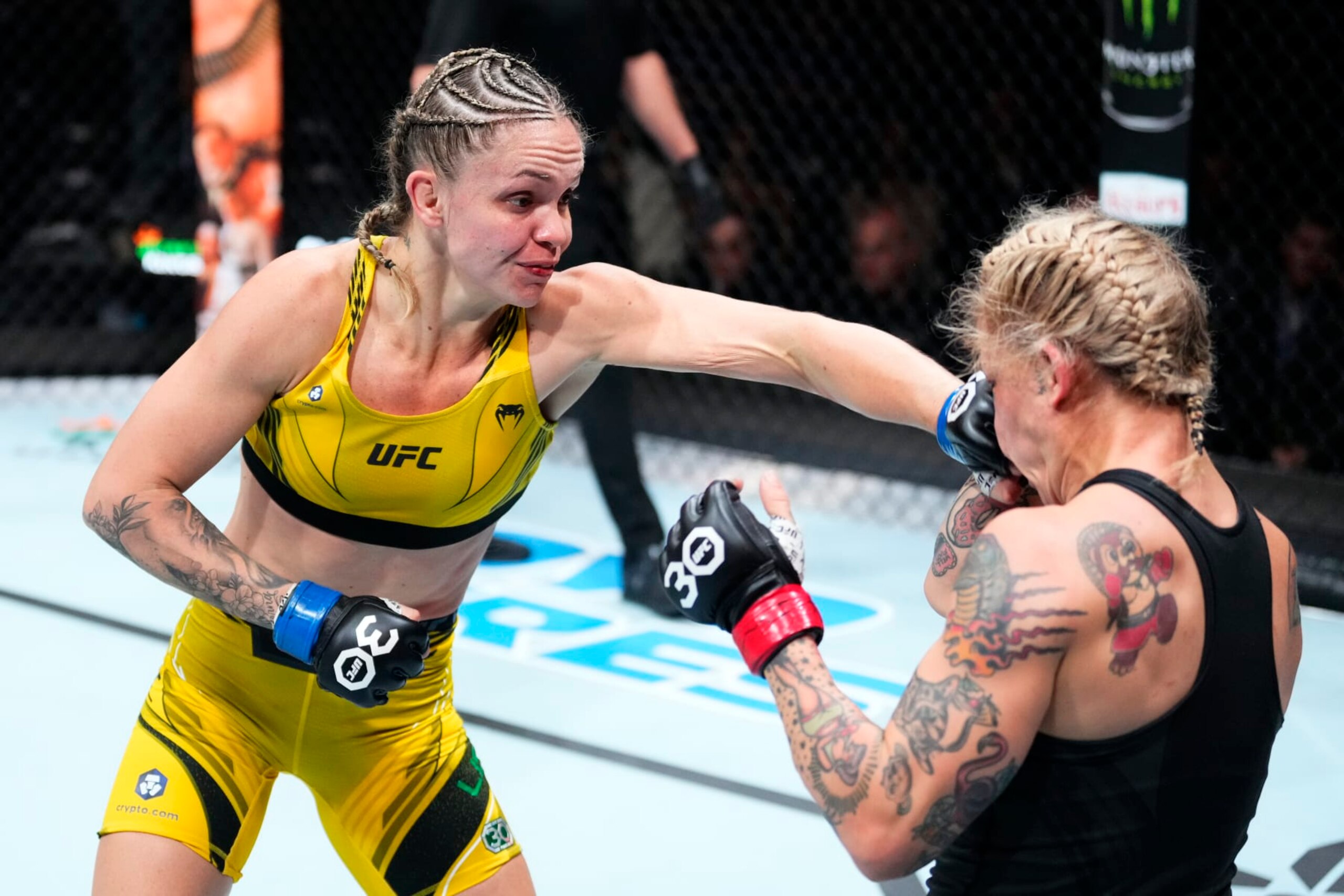 CHARLOTTE, NORTH CAROLINA - MAY 13: (L-R) Tainara Lisboa of Brazil punches Jessica-Rose Clark of Australia in a bantamweight fight during the UFC Fight Night event at Spectrum Center on May 13, 2023 in Charlotte, North Carolina. (Photo by Jeff Bottari/Zuffa LLC via Getty Images)