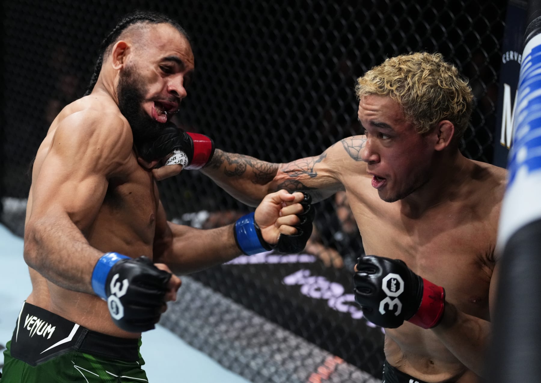 CHARLOTTE, NORTH CAROLINA - MAY 13: (R-L) Bryan Battle knocks out Gabe Green with a punch in a welterweight fight during the UFC Fight Night event at Spectrum Center on May 13, 2023 in Charlotte, North Carolina. (Photo by Jeff Bottari/Zuffa LLC via Getty Images)