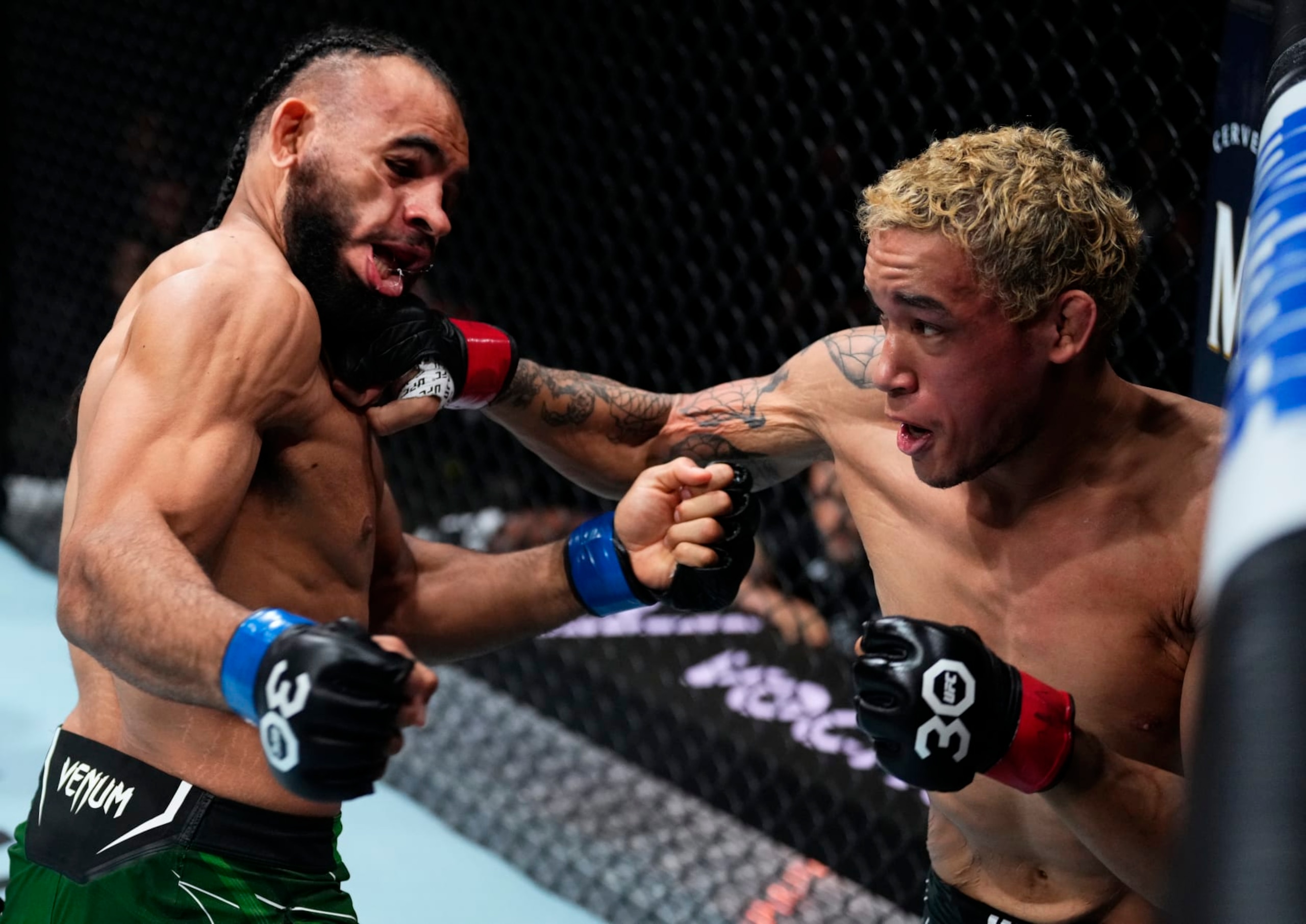 CHARLOTTE, NORTH CAROLINA - MAY 13: (R-L) Bryan Battle knocks out Gabe Green with a punch in a welterweight fight during the UFC Fight Night event at Spectrum Center on May 13, 2023 in Charlotte, North Carolina. (Photo by Jeff Bottari/Zuffa LLC via Getty Images)