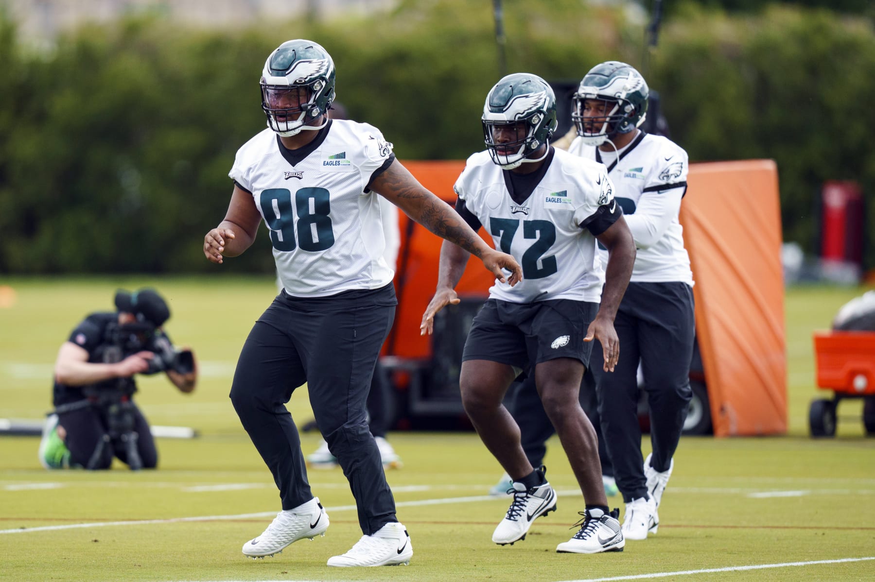 Philadelphia Eagles' Jalen Carter, left, warms up with Moro Ohomo, center, during NFL rookie football minicamp, Friday, May 5, 2023, in Philadelphia. (AP Photo/Chris Szagola)