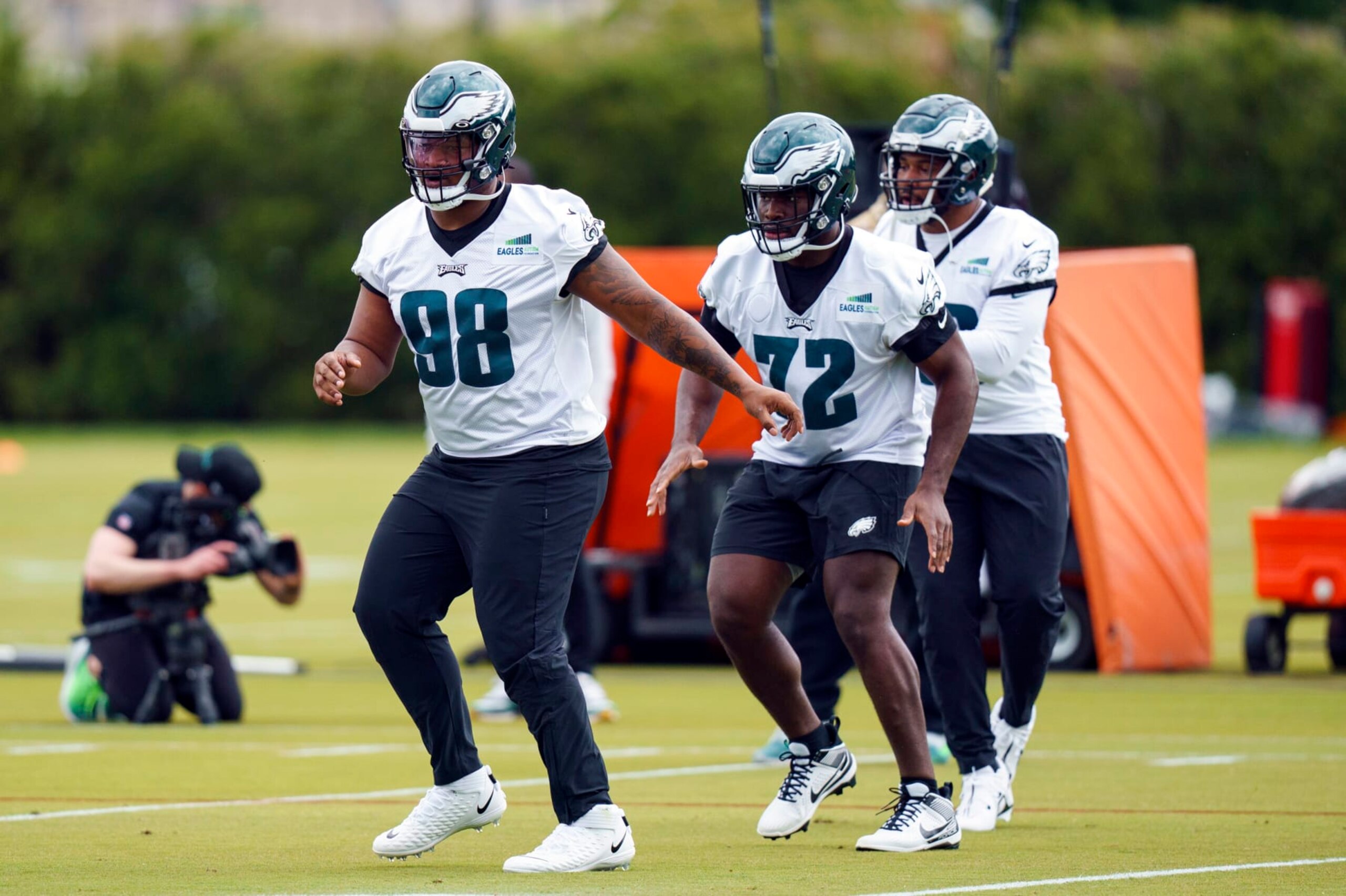 Philadelphia Eagles' Jalen Carter, left, warms up with Moro Ohomo, center, during NFL rookie football minicamp, Friday, May 5, 2023, in Philadelphia. (AP Photo/Chris Szagola)