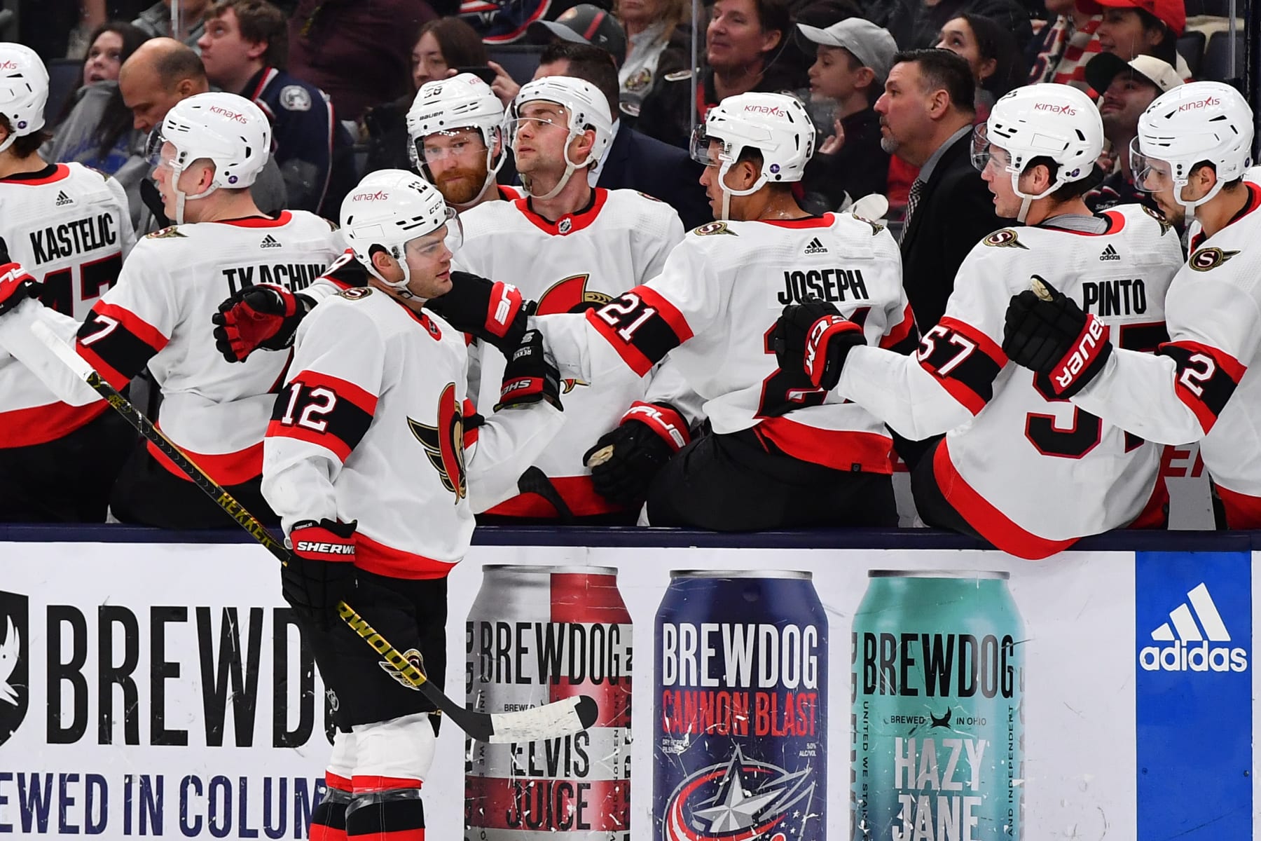 COLUMBUS, OHIO - APRIL 2: Alex DeBrincat #12 of the Ottawa Senators high fives his teammates after scoring a goal during the first period of a game against the Columbus Blue Jackets at Nationwide Arena on April 2, 2023 in Columbus, Ohio. (Photo by Ben Jackson/NHLI via Getty Images)
