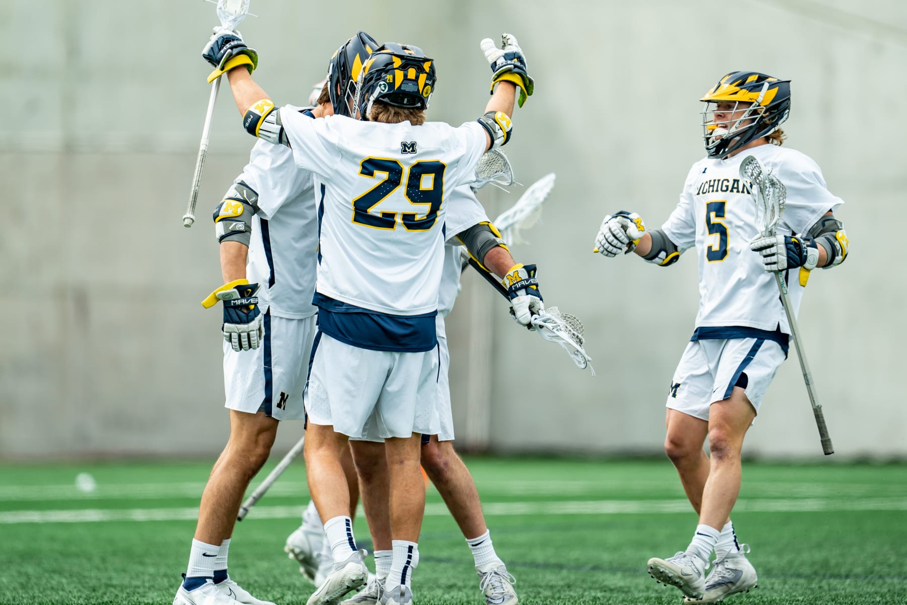 ANN ARBOR, MI - APRIL 29: Jacob Jackson #15, Bryce Clay #3, Peter Thompson #29 and Michael Boehm #5 of the Michigan Wolverines celebrate a first quarter goal against the Ohio State Buckeyes at U-M Lacrosse Stadium on April 29, 2023 in Ann Arbor, Michigan. (Photo by Jaime Crawford/Getty Images)