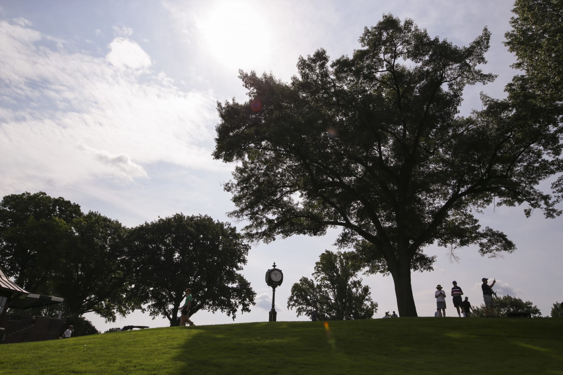 ROCHESTER, NEW YORK - SEPTEMBER 18: People watch from a hill during the Drive, Chip & Putt regional qualifier at Oak Hill Country Club on September 18, 2022 in Rochester, New York. (Photo by Joshua Bessex/Getty Images for the DC&P Championship)