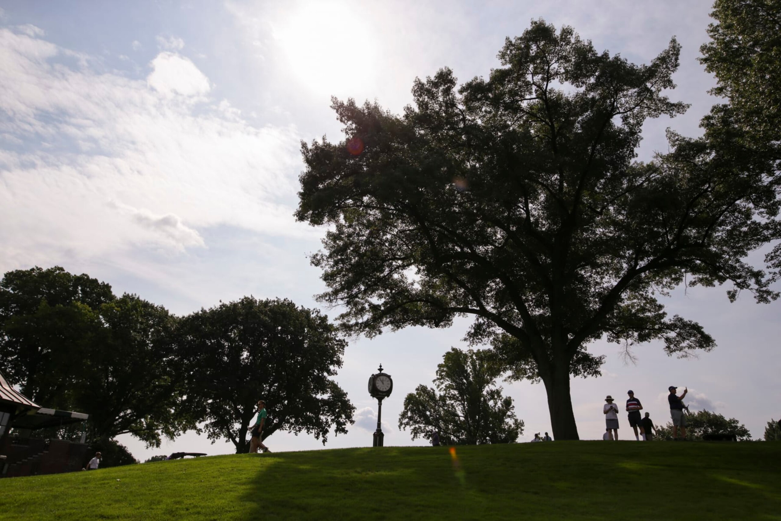 ROCHESTER, NEW YORK - SEPTEMBER 18: People watch from a hill during the Drive, Chip & Putt regional qualifier at Oak Hill Country Club on September 18, 2022 in Rochester, New York. (Photo by Joshua Bessex/Getty Images for the DC&P Championship)