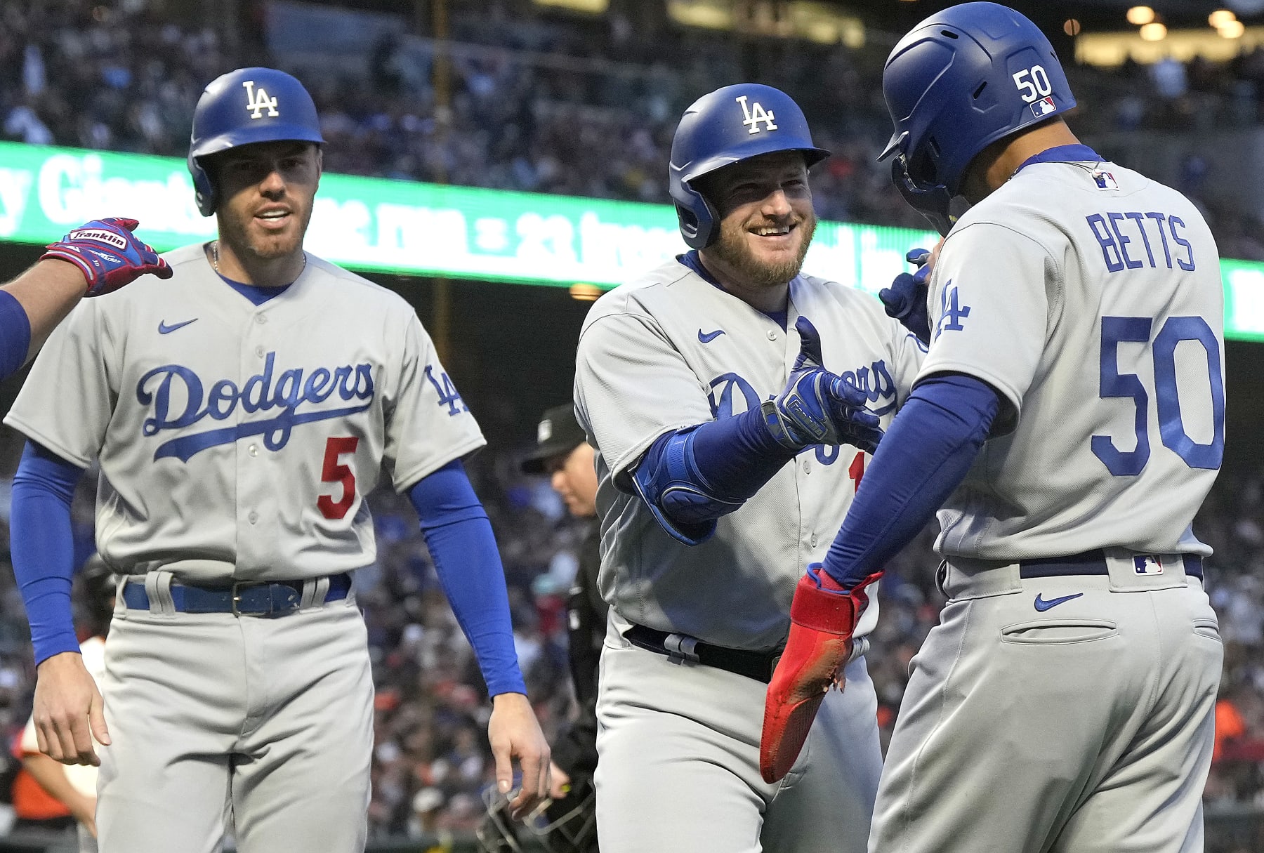SAN FRANCISCO, CALIFORNIA - APRIL 10: Max Muncy #13 of the Los Angeles Dodgers is congratulated by Mookie Betts #50 and Freddie Freeman #5 after hitting a three-run home run against the San Francisco Giants in the top of the third inning at Oracle Park on April 10, 2023 in San Francisco, California. (Photo by Thearon W. Henderson/Getty Images)