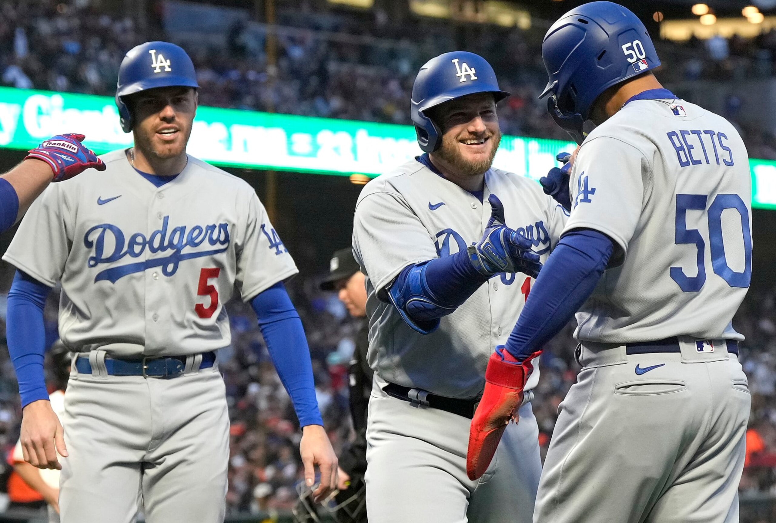 SAN FRANCISCO, CALIFORNIA - APRIL 10: Max Muncy #13 of the Los Angeles Dodgers is congratulated by Mookie Betts #50 and Freddie Freeman #5 after hitting a three-run home run against the San Francisco Giants in the top of the third inning at Oracle Park on April 10, 2023 in San Francisco, California. (Photo by Thearon W. Henderson/Getty Images)