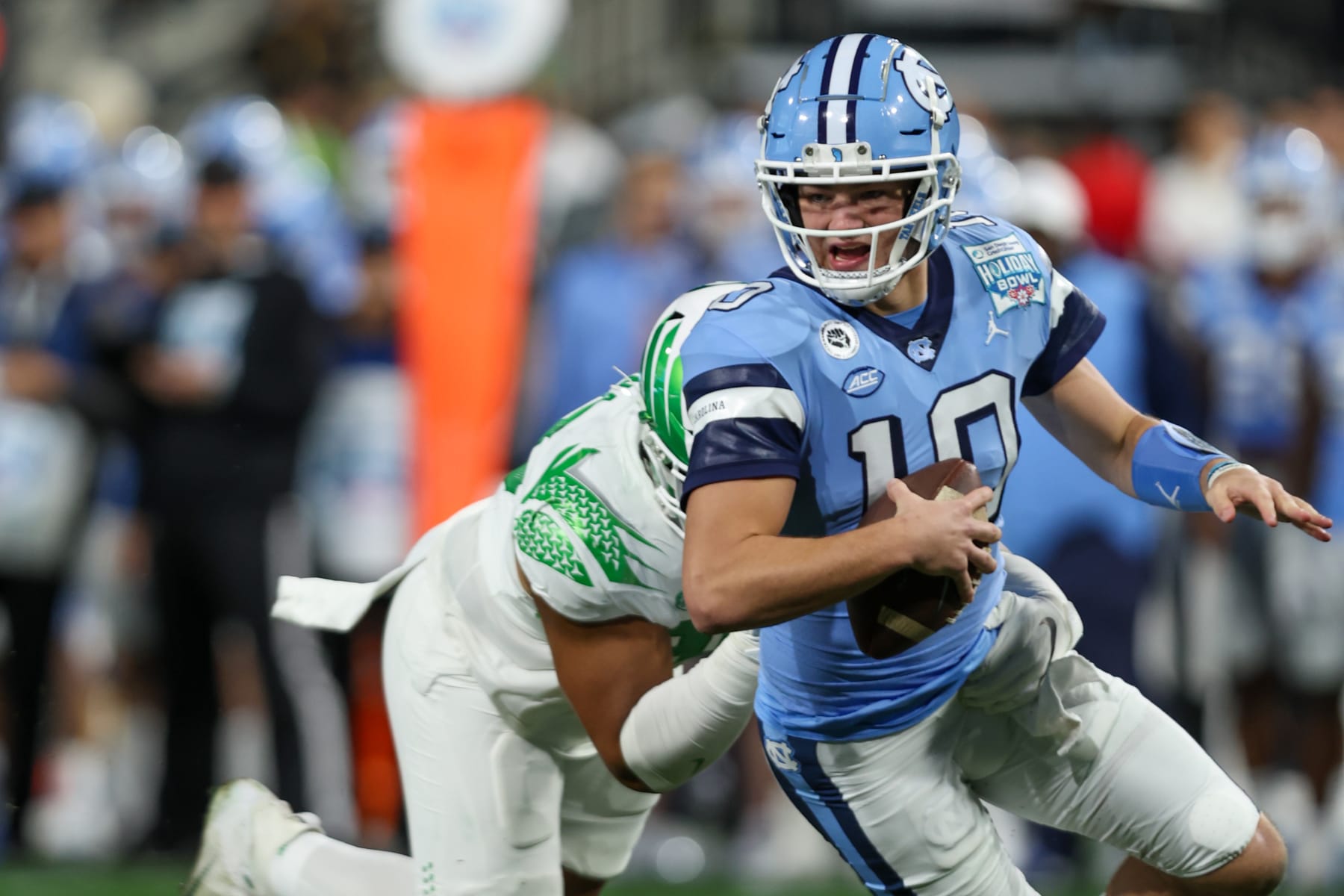 SAN DIEGO, CA - DECEMBER 28: North Carolina Tar Heels quarterback Drake Maye (10) is pressured out out of the pocket during the San Diego County Credit Union Holiday Bowl football game between the Oregon Ducks and the North Carolina Tar Heels on December 28, 2022, at Petco Park in San Diego, CA. (Photo by Jordon Kelly/Icon Sportswire via Getty Images)