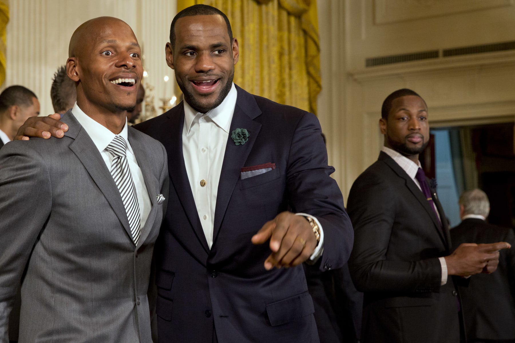 Miami Heat basketball players Ray Allen, left, and LeBron James look out into the crowd, next to Dwyane Wade, after a ceremony in the East Room of the White House in Washington, Tuesday, Jan. 14, 2014, where President Barack Obama honored the Miami Heat 2013 NBA Champion basketball team. (AP Photo/Jacquelyn Martin)
