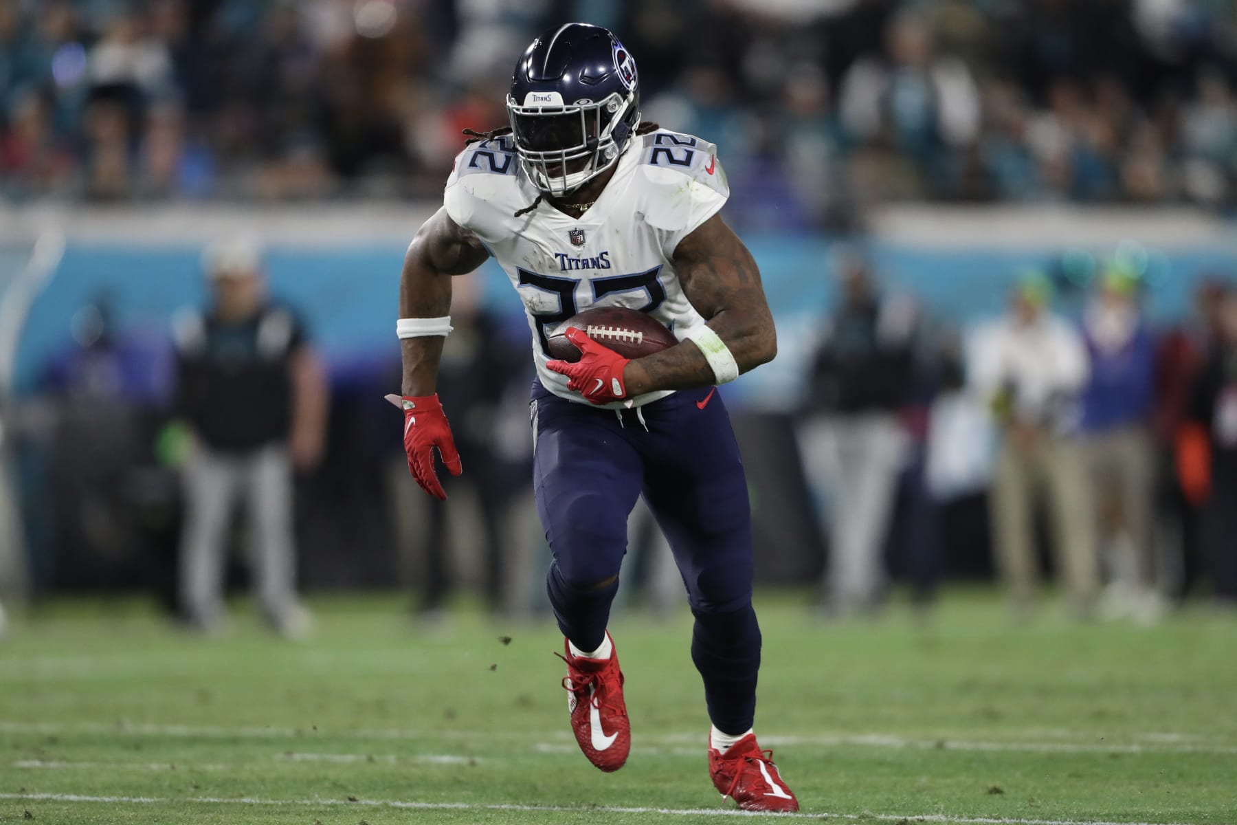 JACKSONVILLE, FLORIDA - JANUARY 07: Derrick Henry #22 of the Tennessee Titans carries the ball during the first half against the Jacksonville Jaguars at TIAA Bank Field on January 07, 2023 in Jacksonville, Florida. (Photo by Courtney Culbreath/Getty Images)