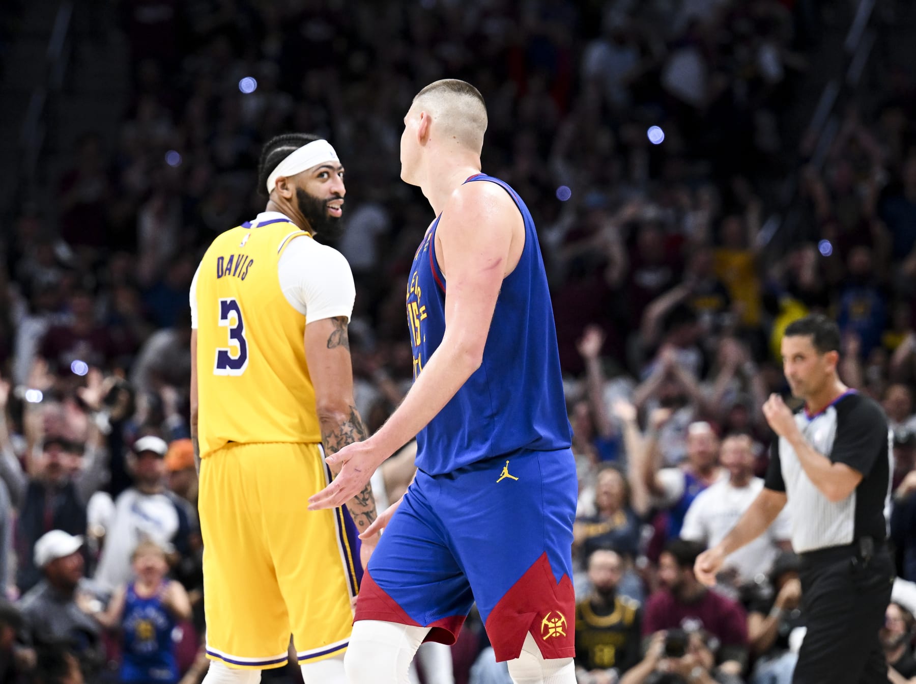 DENVER, CO - MAY 16: Los Angeles Lakers forward Anthony Davis, left, reacts after a three-point basket by Denver Nuggets center Nikola Jokic during the second half of game one in the NBA Playoffs Western Conference Finals at Ball Arena on Tuesday, May 16, 2023 in Denver, CO. (Wally Skalij / Los Angeles Times via Getty Images)