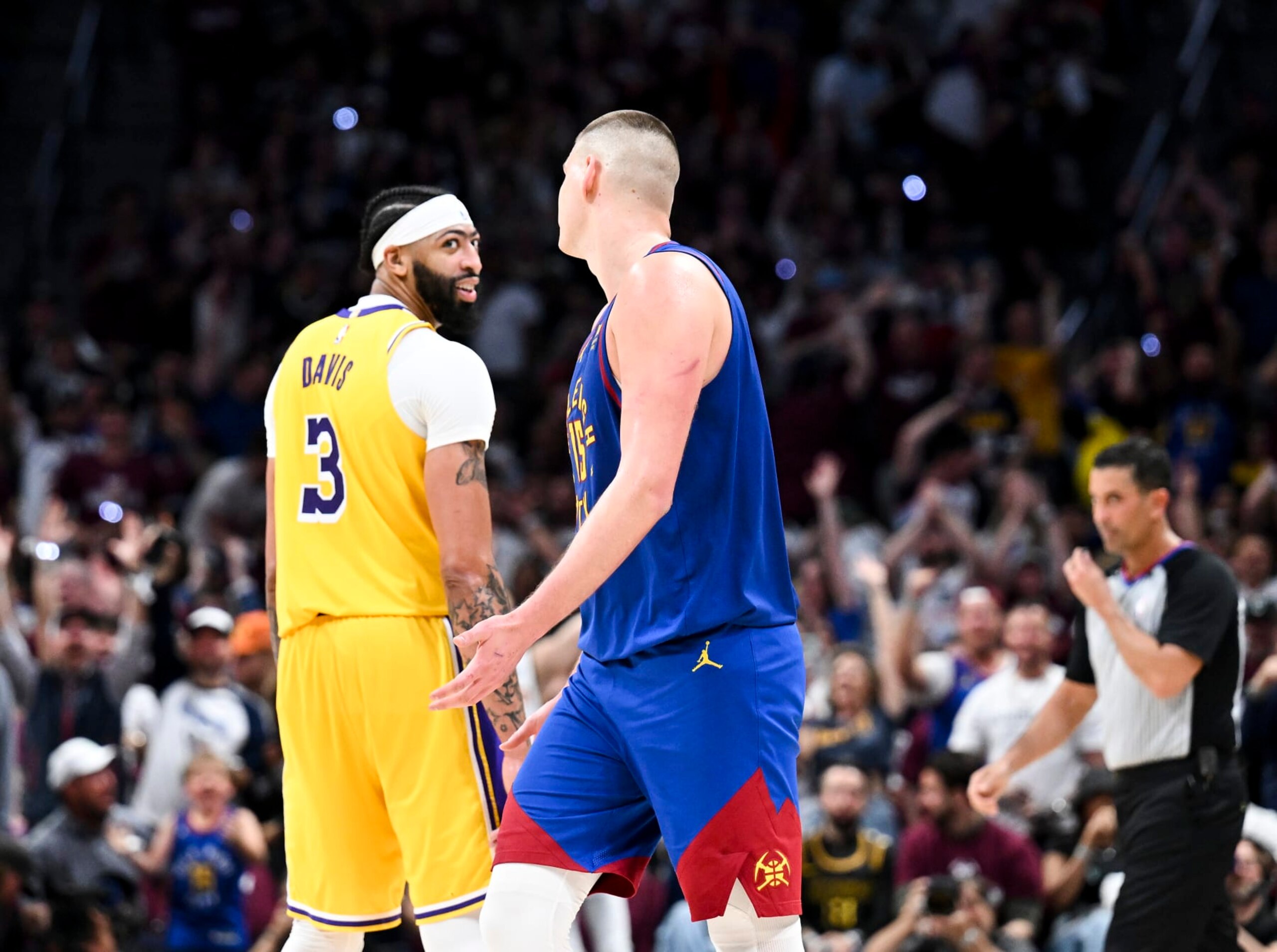 DENVER, CO - MAY 16: Los Angeles Lakers forward Anthony Davis, left, reacts after a three-point basket by Denver Nuggets center Nikola Jokic during the second half of game one in the NBA Playoffs Western Conference Finals at Ball Arena on Tuesday, May 16, 2023 in Denver, CO. (Wally Skalij / Los Angeles Times via Getty Images)