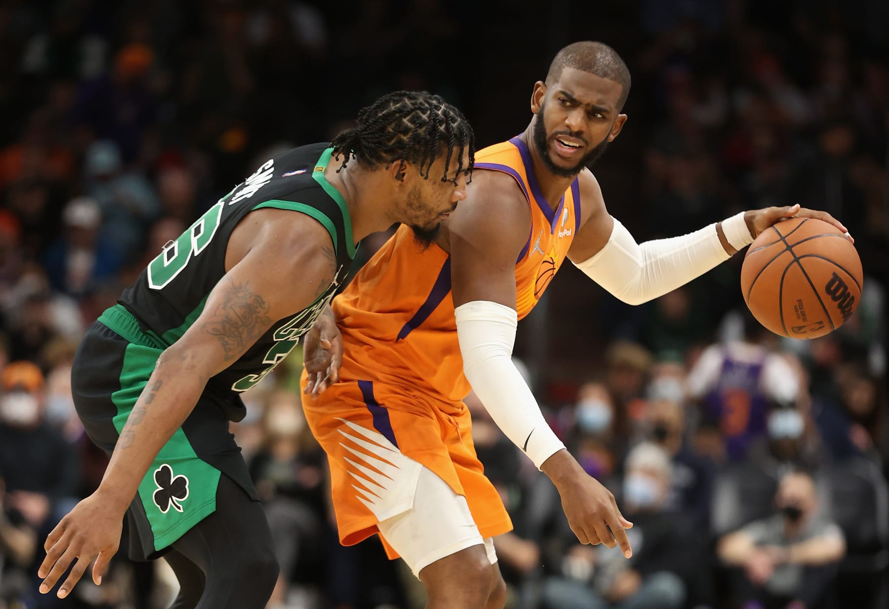 PHOENIX, ARIZONA - DECEMBER 10: Chris Paul #3 of the Phoenix Suns handles the ball against Marcus Smart #36 of the Boston Celtics during the second half of the NBA game at Footprint Center on December 10, 2021 in Phoenix, Arizona. NOTE TO USER: User expressly acknowledges and agrees that, by downloading and or using this photograph, User is consenting to the terms and conditions of the Getty Images License Agreement.  (Photo by Christian Petersen/Getty Images)