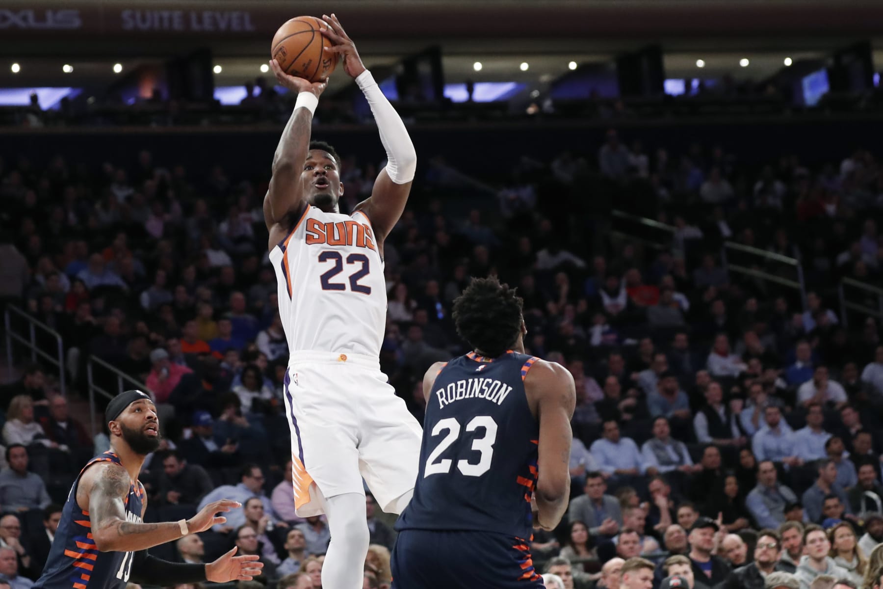 Phoenix Suns center Deandre Ayton (22) shoots with New York Knicks forward Marcus Morris Sr. (13) and Knicks center Mitchell Robinson (23) looking on during the second half of an NBA basketball game in New York, Thursday, Jan. 16, 2020. The Suns defeated the Knicks 121-98. (AP Photo/Kathy Willens)