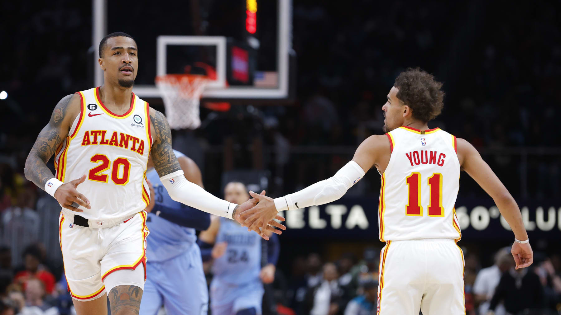 ATLANTA, GA - MARCH 26: John Collins #20 reacts with Trae Young #11 of the Atlanta Hawks during the second half against the Memphis Grizzlies at State Farm Arena on March 26, 2023 in Atlanta, Georgia. NOTE TO USER: User expressly acknowledges and agrees that, by downloading and or using this photograph, User is consenting to the terms and conditions of the Getty Images License Agreement. (Photo by Todd Kirkland/Getty Images)
