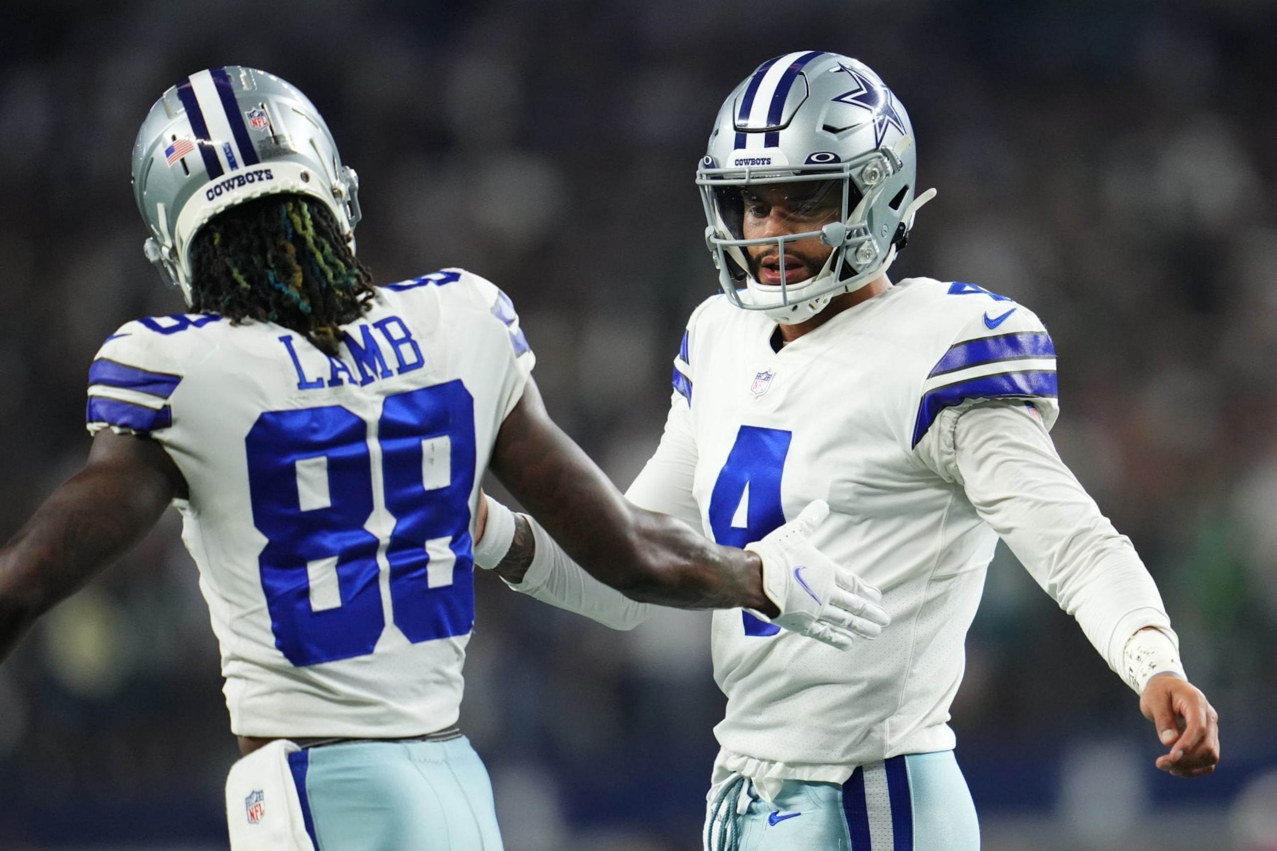 ARLINGTON, TEXAS - SEPTEMBER 27: Dak Prescott #4 of the Dallas Cowboys celebrates with wide receiver CeeDee Lamb (88) against the Philadelphia Eagles during an NFL game at AT&T Stadium on September 27, 2021 in Arlington, Texas. (Photo by Cooper Neill/Getty Images)