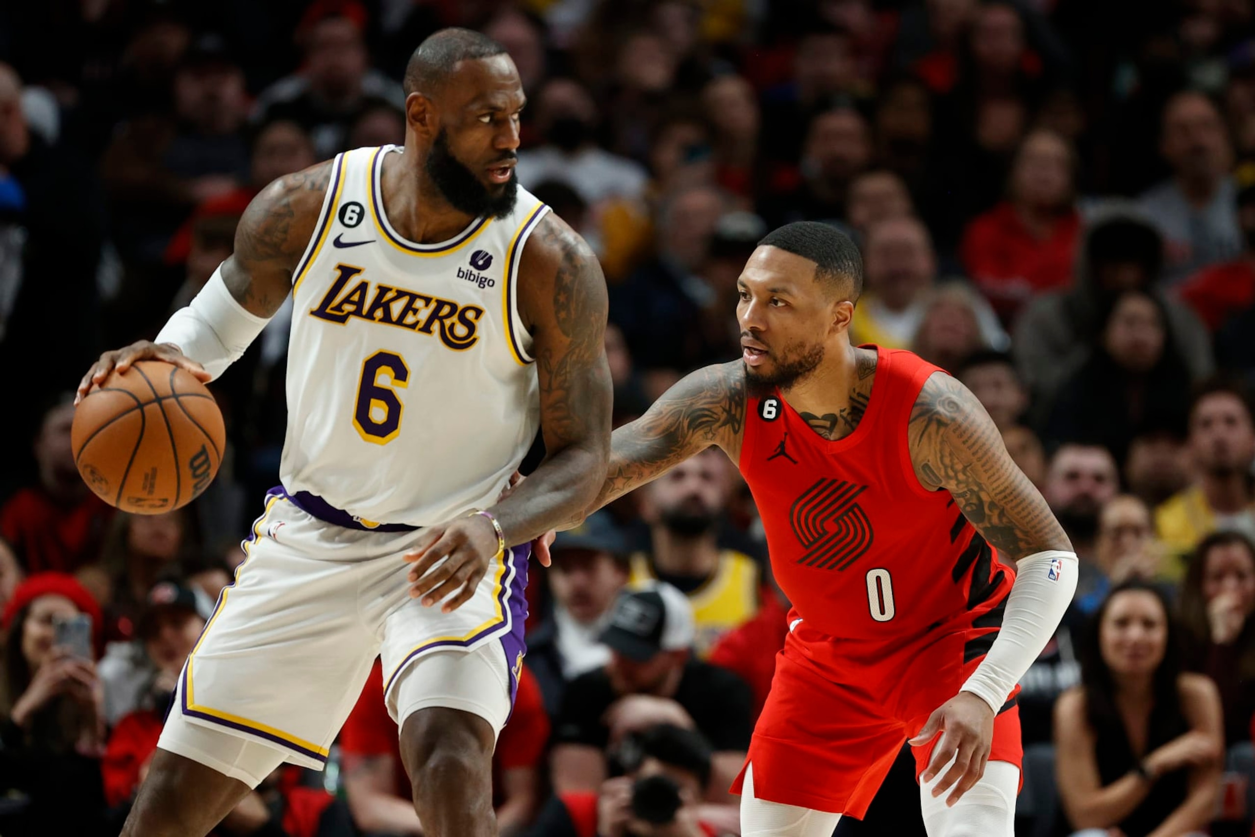 PORTLAND, OREGON - JANUARY 22: LeBron James #6 of the Los Angeles Lakers dribbles against Damian Lillard #0 of the Portland Trail Blazers during the fourth quarter at Moda Center on January 22, 2023 in Portland, Oregon. NOTE TO USER: User expressly acknowledges and agrees that, by downloading and/or using this photograph, User is consenting to the terms and conditions of the Getty Images License Agreement. (Photo by Steph Chambers/Getty Images)